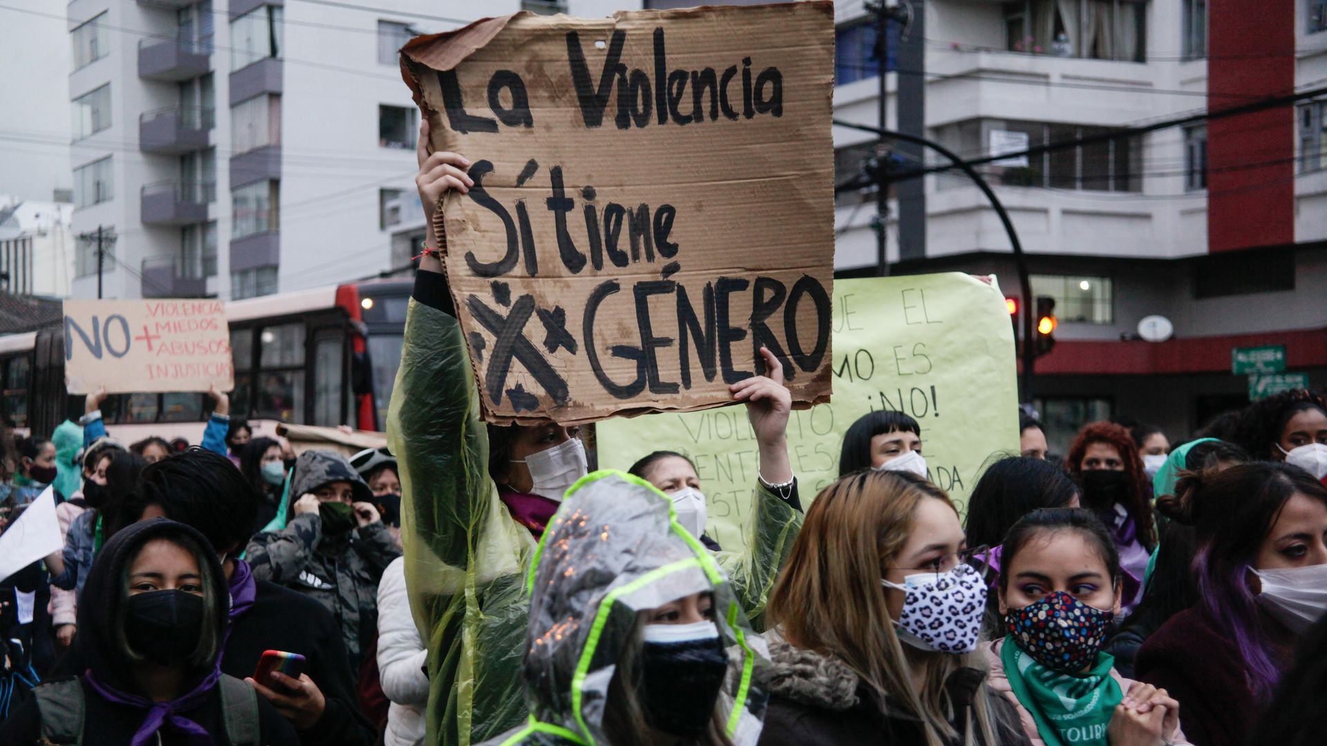 The 2021 A woman holds up a sign in Spanish that translates to "Violence does have gender" at the Women’s Day march in Quito, Ecuador.