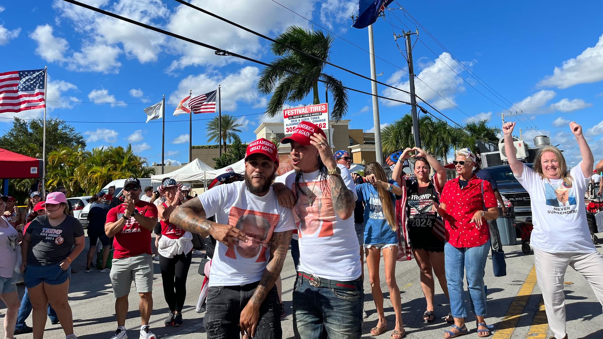 The Florida musical group Trump Latinos films a music video outside the rally as supporters dance behind them.