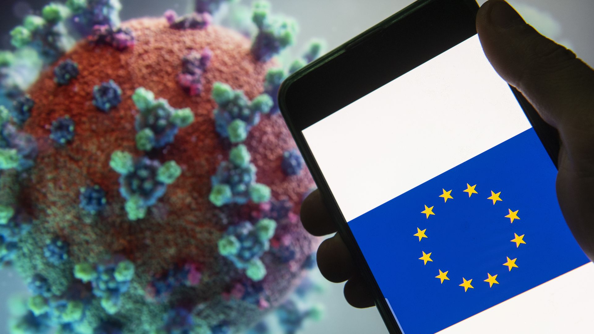The EU symbol in front of an image of the coronavirus.