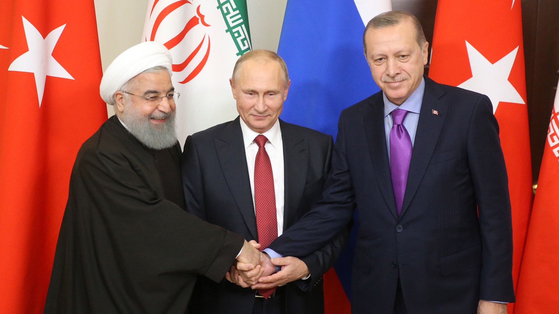 Russian President Vladimir Putin pose for a photo with Turkish President Recep Tayyip Erdogan and Iranian President Hassan Rouhani prior to their talks at Black Sea resort state residence