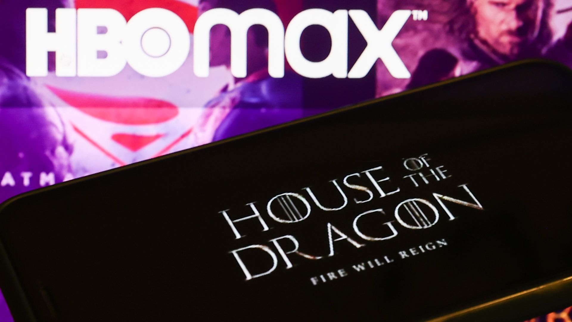 House of the Dragon' series logo displayed on a phone screen and HBO Max website displayed on a laptop screen are seen in this 