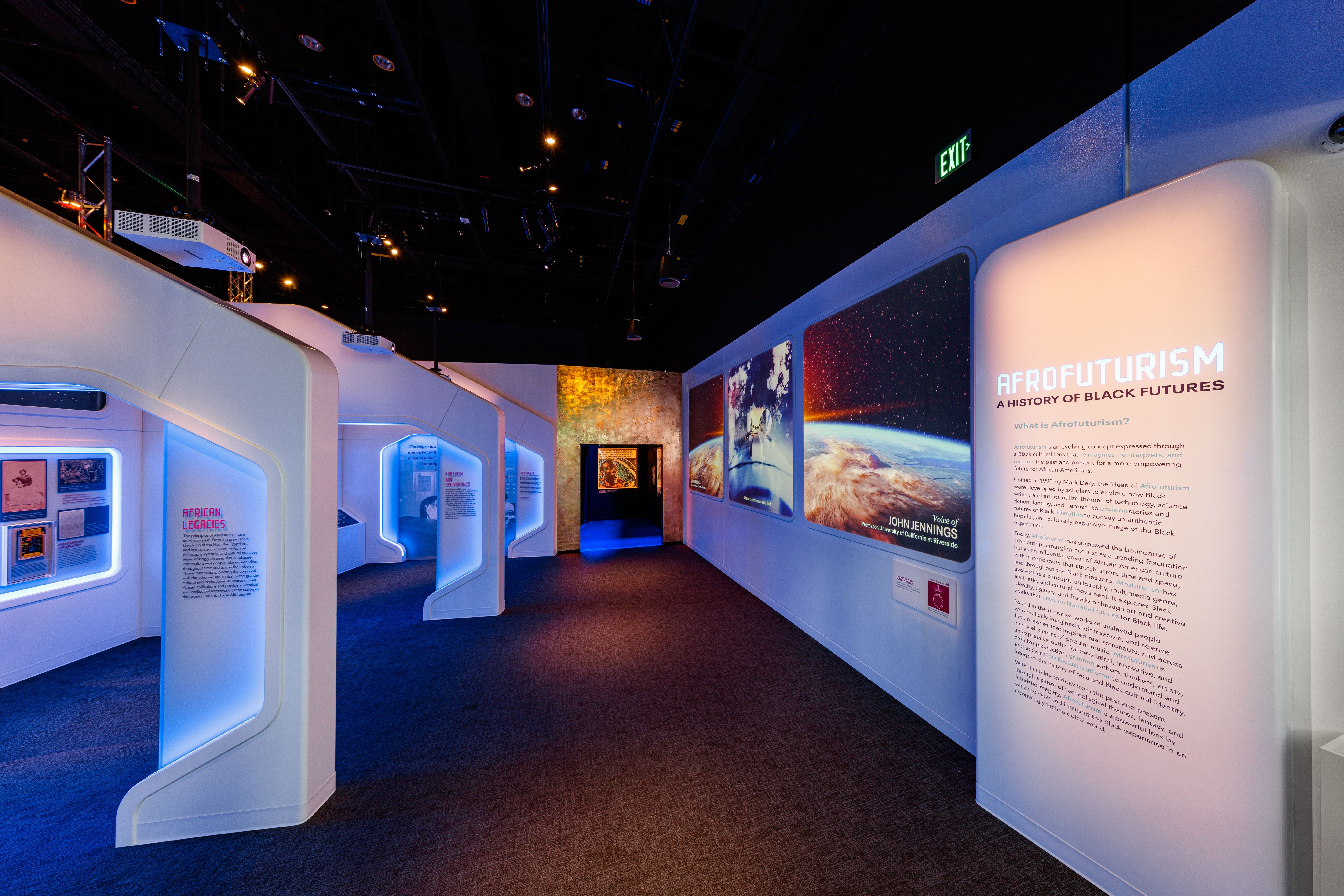 A long room with white exhibits on the side and the words AFROFUTURISM to the right