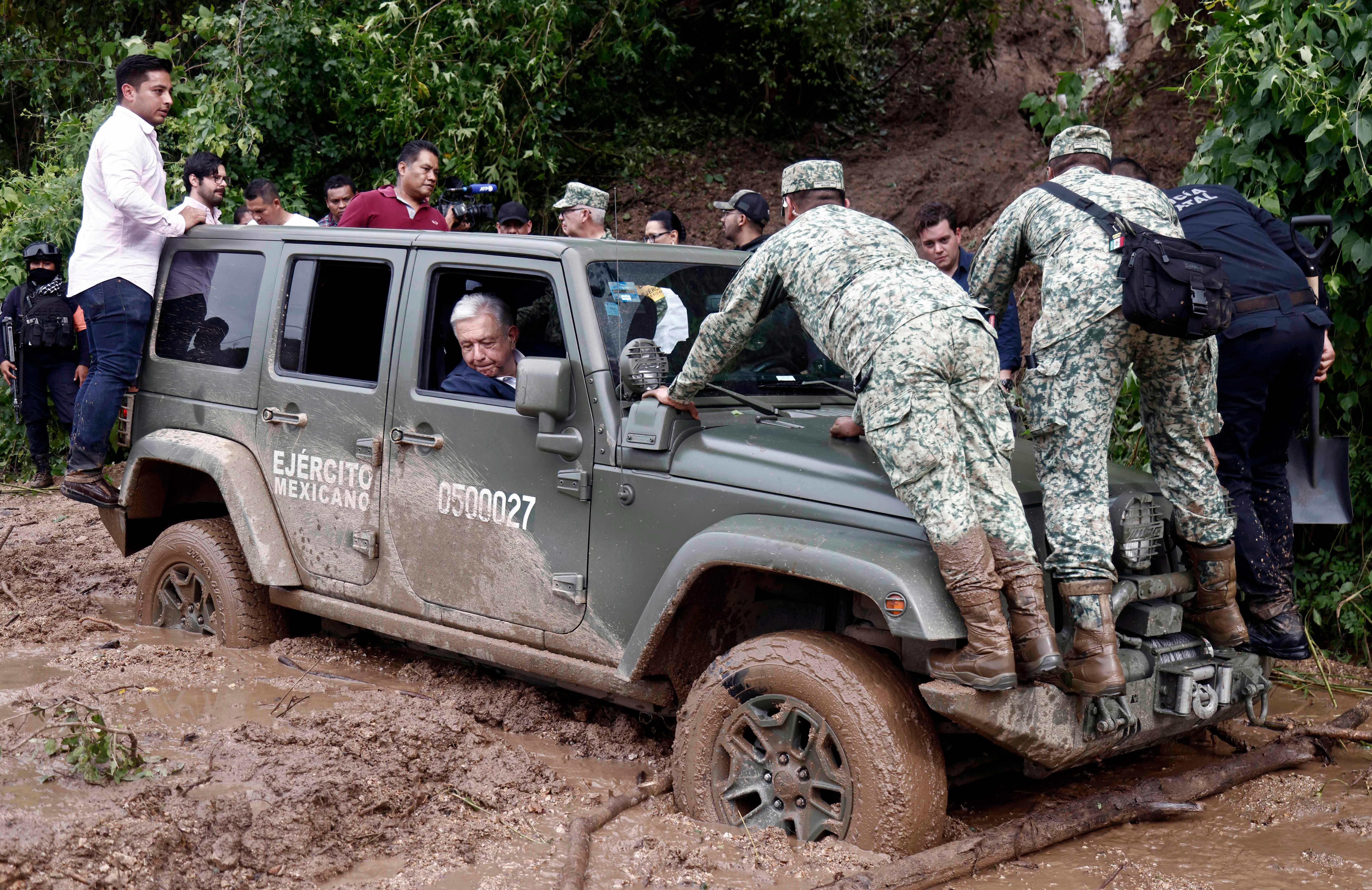 Mexican President Andres Manuel Lopez Obrador looking out of the window of a vehicle stuck in mud near Acapulco on Oct. 25.