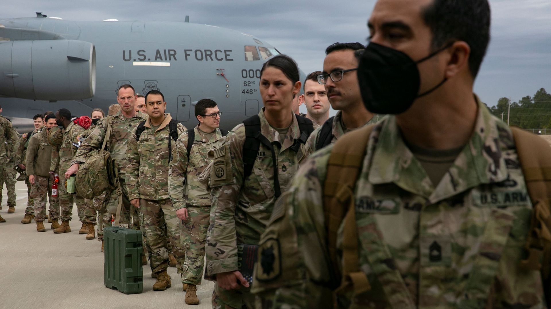 U.S. troops are seen waiting to board a transport plane to head to Europe.