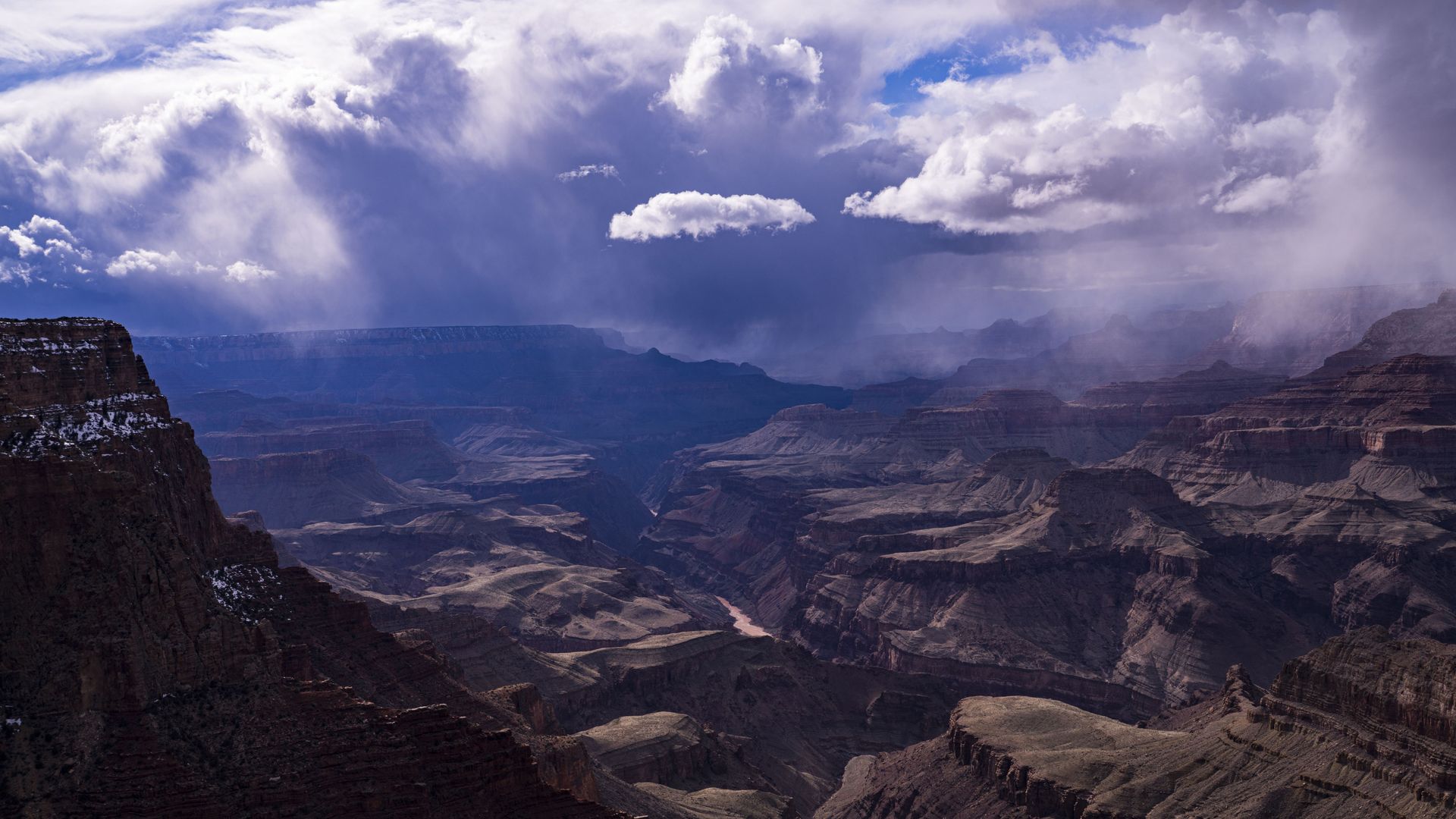 The grand canyon with snow falling.