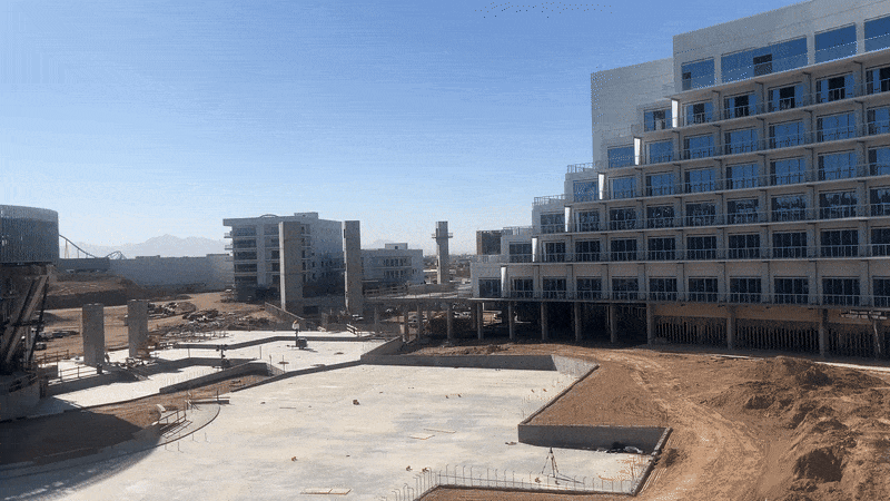 A gif of an amphitheater and hotel under construction. 
