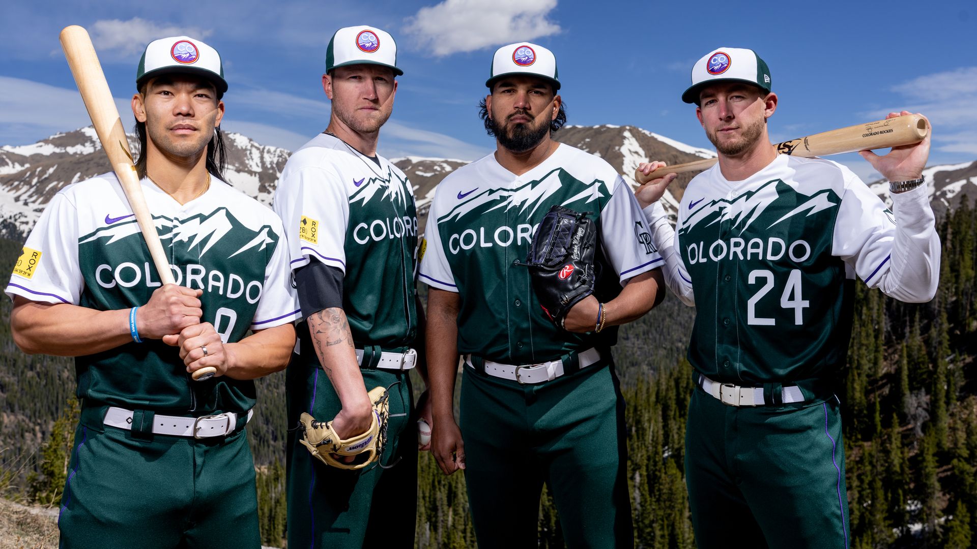 Rockies baseball players wear new green and white City Connect uniforms. 