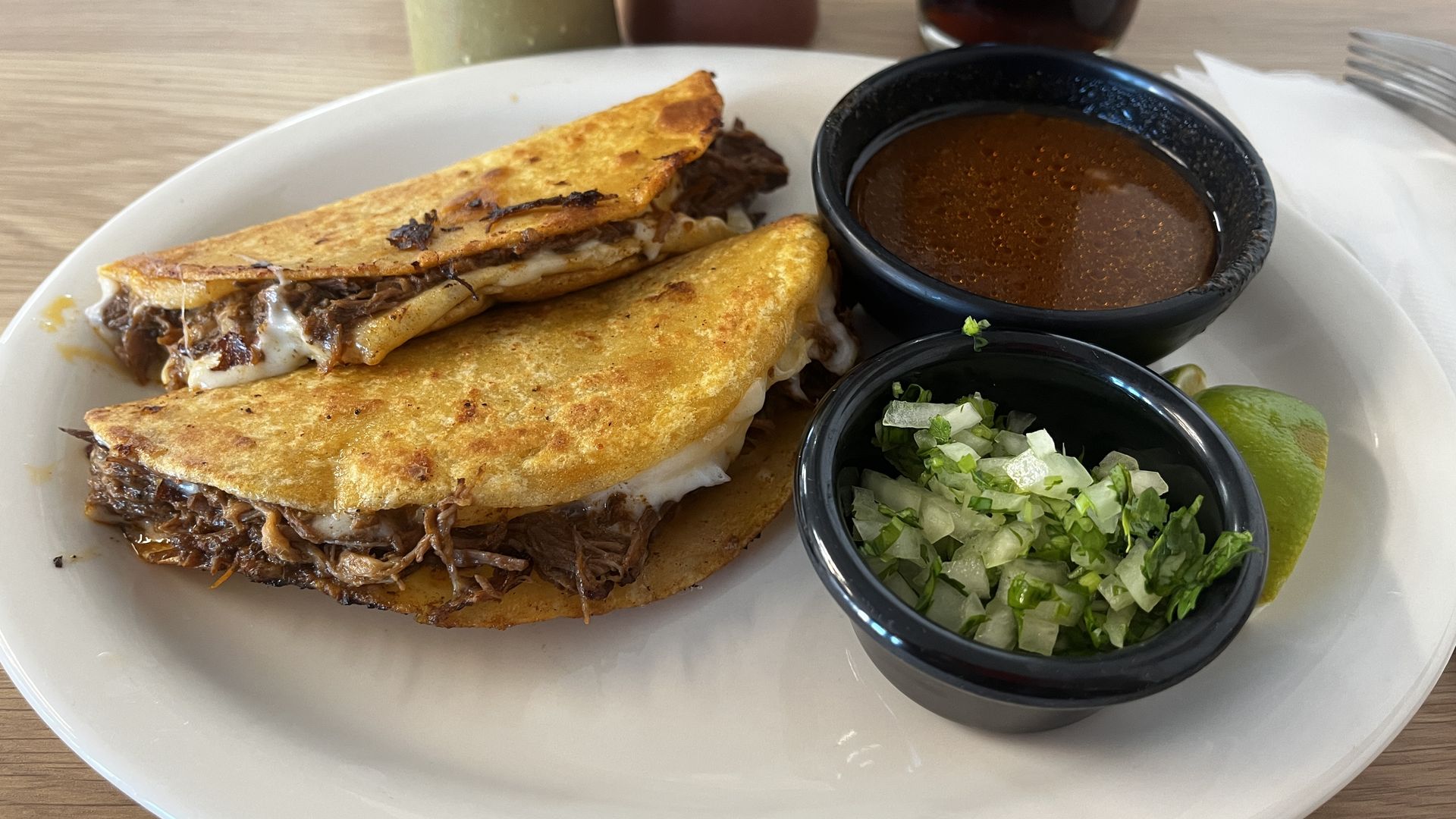 Two quesabirria tacos.