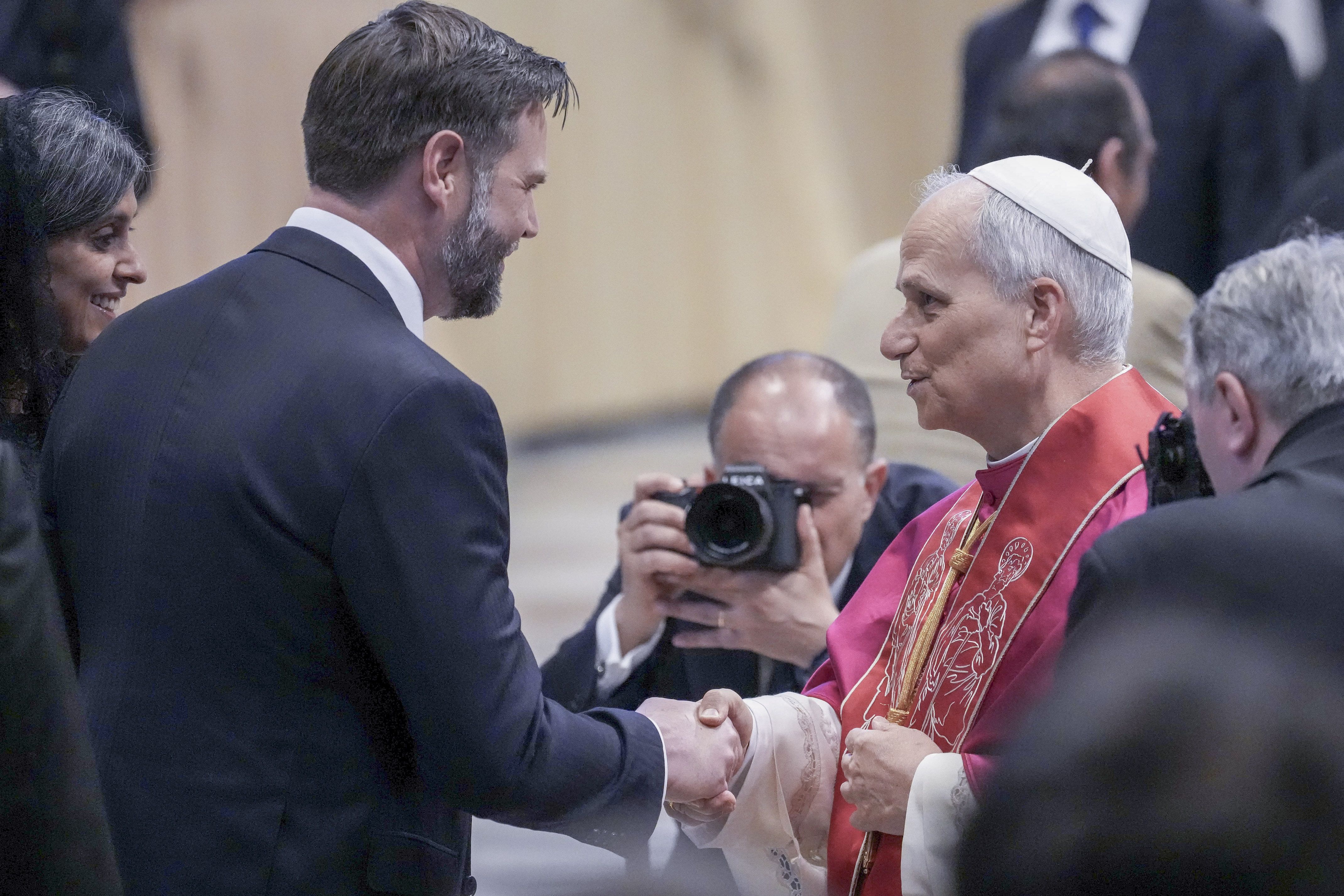 Pope Leo XIV shakes hands with Vice President JD Vance during his inaugural Mass in St. Peter's Square yesterday.