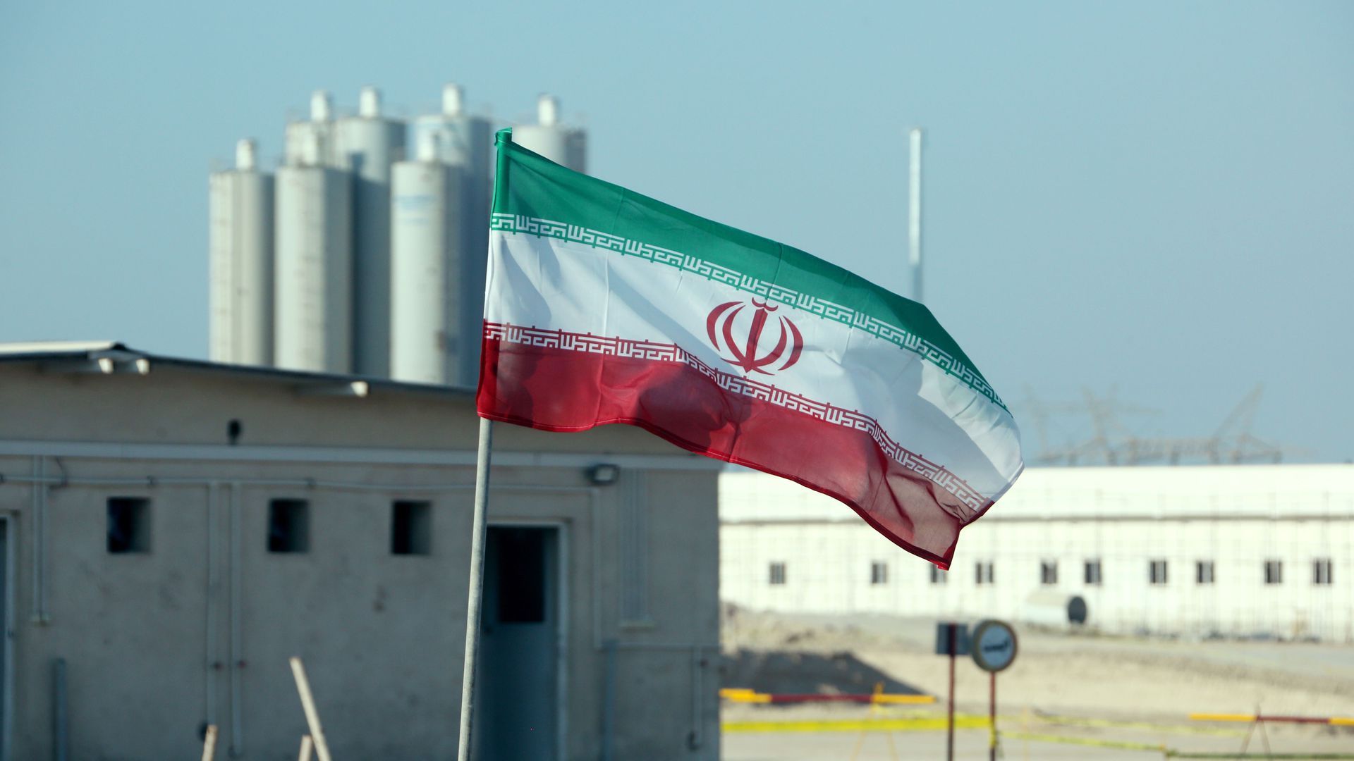 An Iranian flag in front of Iran's Bushehr nuclear power plant