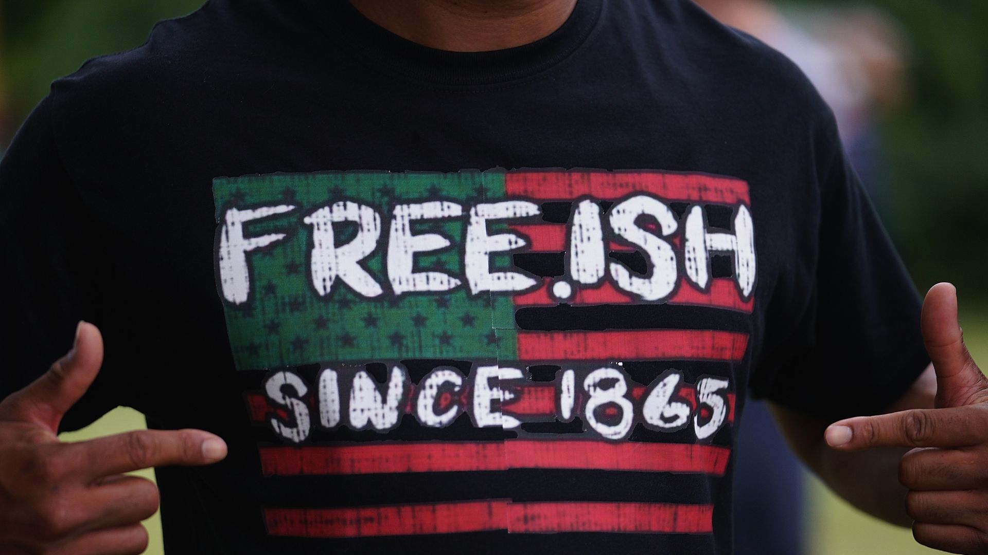  A man displays a shirt celebrating the freedom of enslaved Black people during the Juneteenth celebration on June 19, 2020 in Tulsa, Okla.