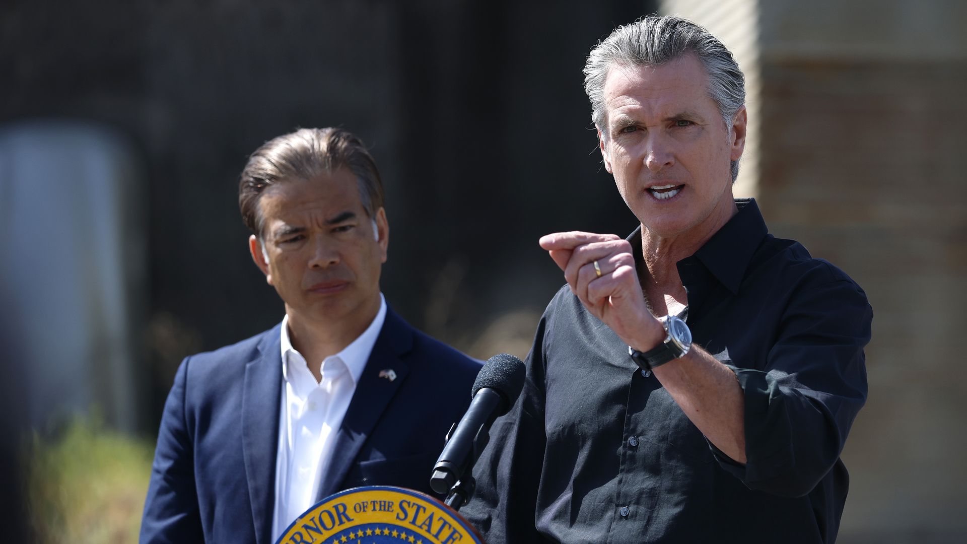 California Governor Gavin Newsom (R) speaks as California Attorney general Rob Bonta looks on during a news conference at Gemperle Orchard on April 16, 2025 in Ceres, California.
