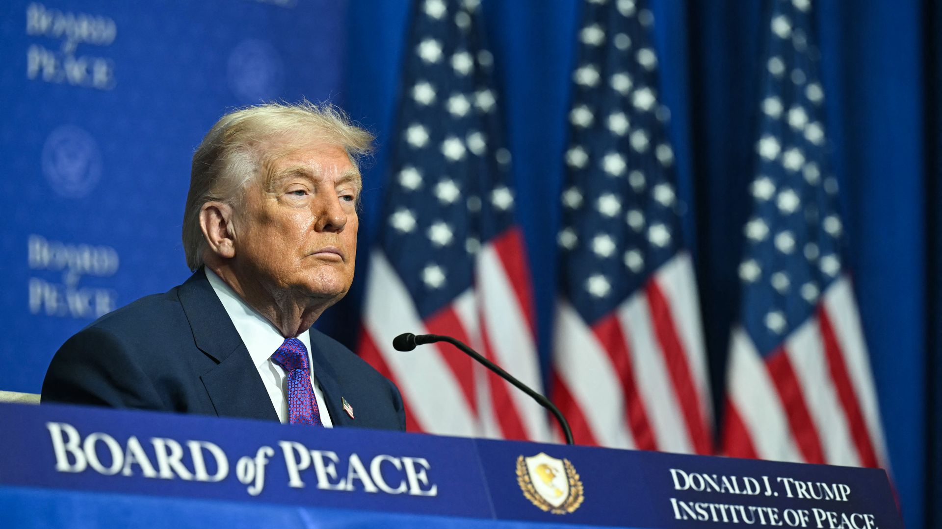Man sits at table with his name on it
