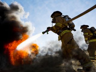 A firefighter operates a water hose during the Major Accident Response  Exercise (MARE) - NARA & DVIDS Public Domain Archive Public Domain Search