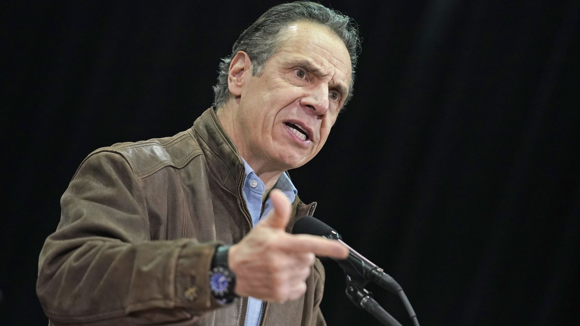 Andrew Cuomo speaks into a microphone