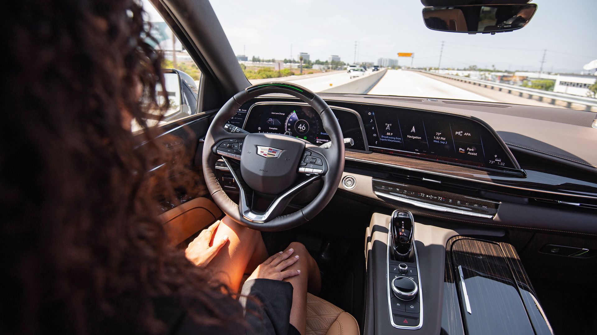 Image of a woman with her hands in her lap inside a Cadillac Escalade with Super Cruise assisted-driving technology 