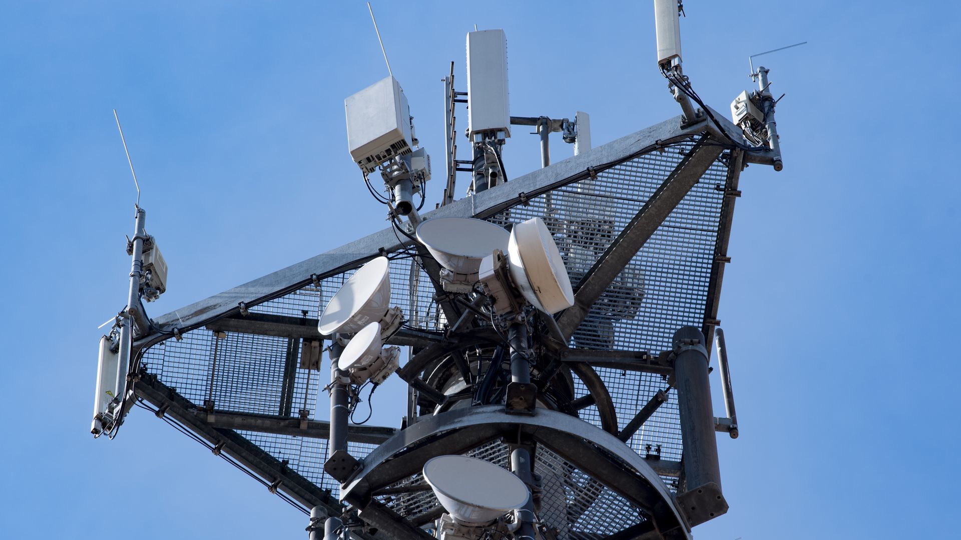 Photo of an advanced black cellphone tower framed against a blue sky
