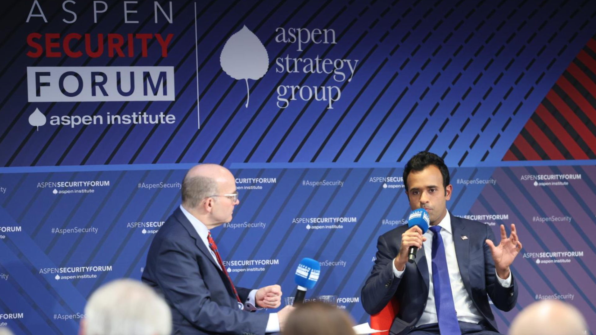 Photo of Mike Allen and Vivek Ramaswamy sitting next to each other on stage during an interview. 