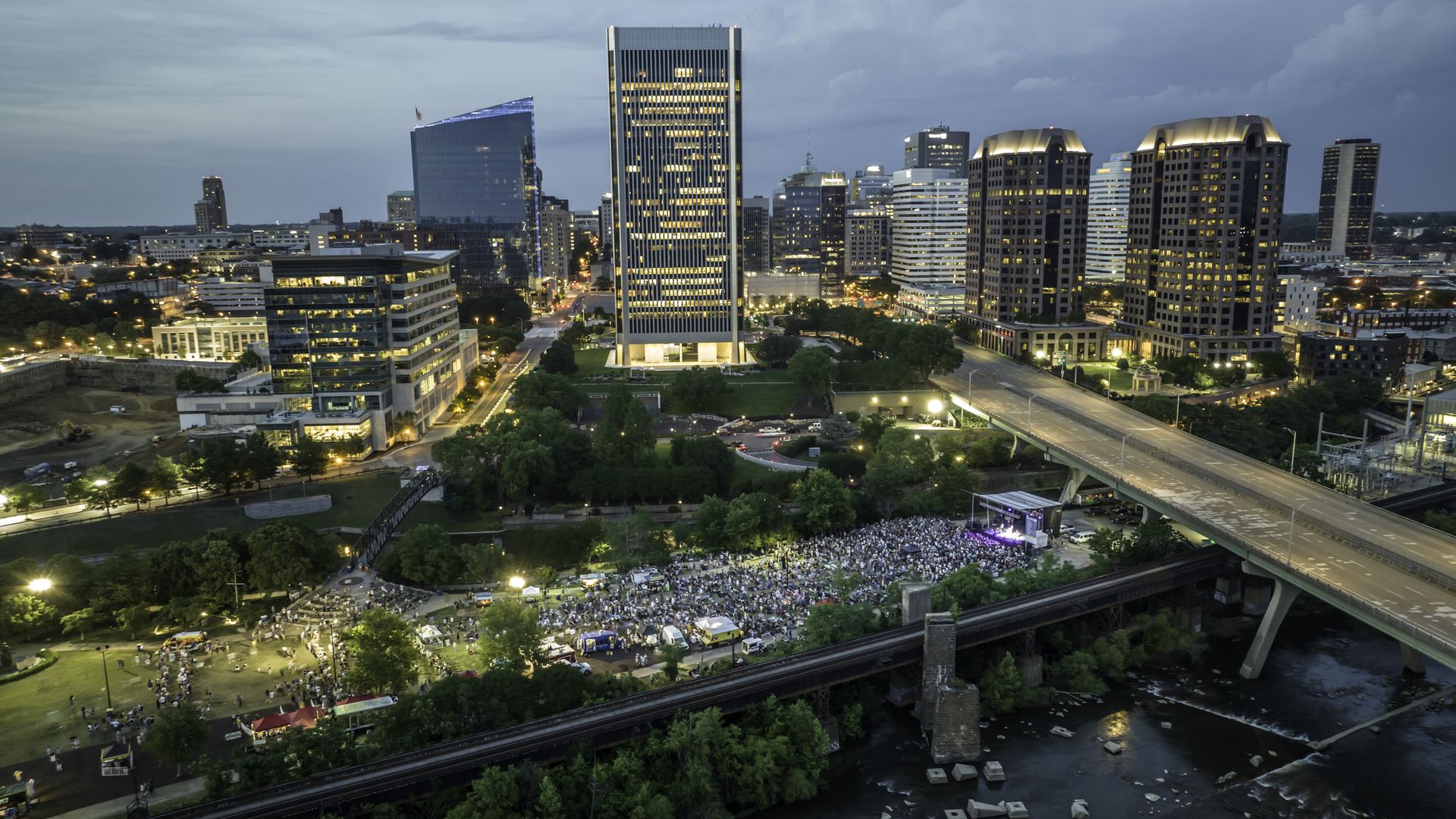 a large crowd of people in a green space as taken from the sky 