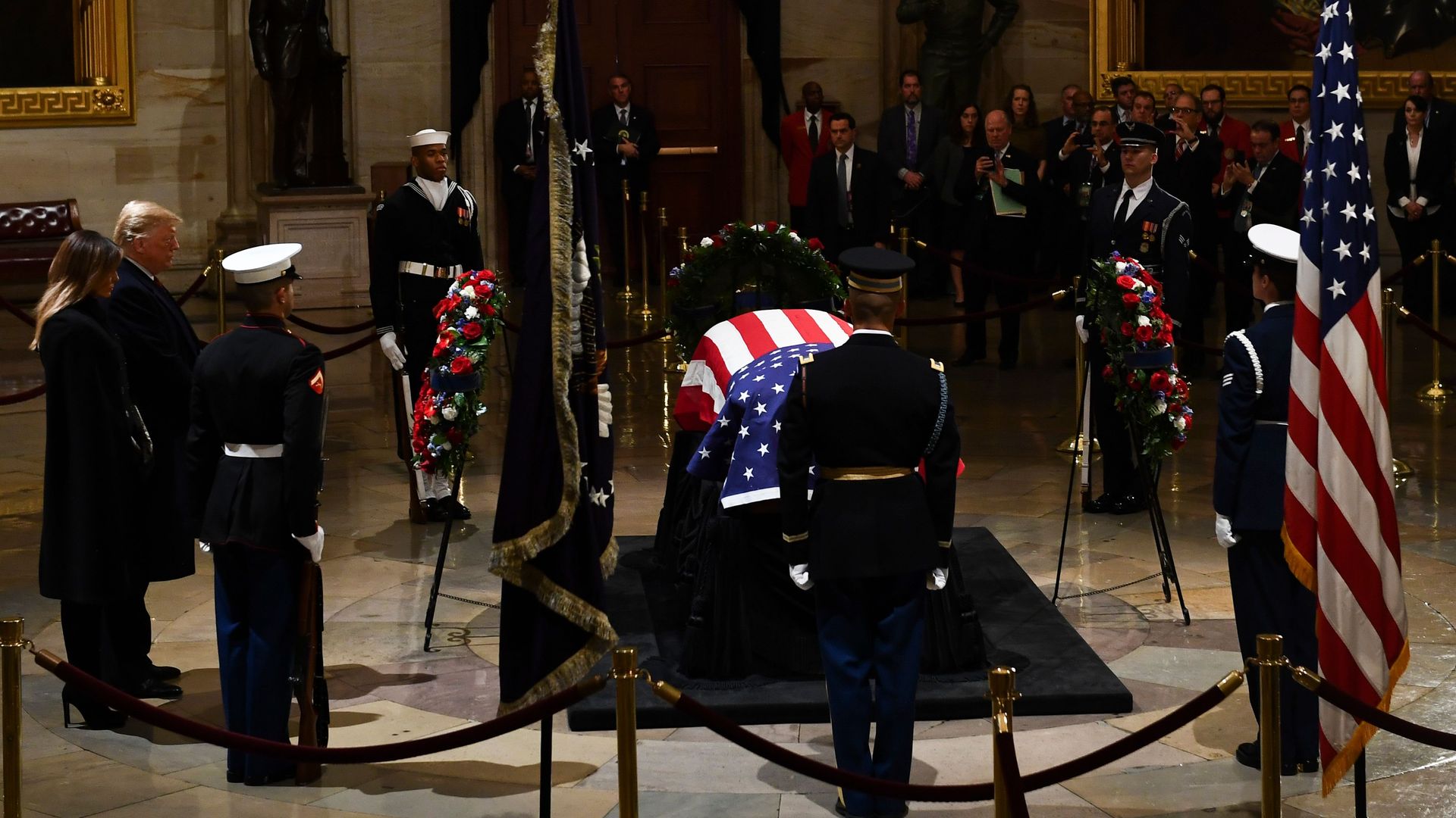 President Donald Trump and his wife Melania Trump arrive to pay their respects to former US President George H. W. Bush as he lies in state