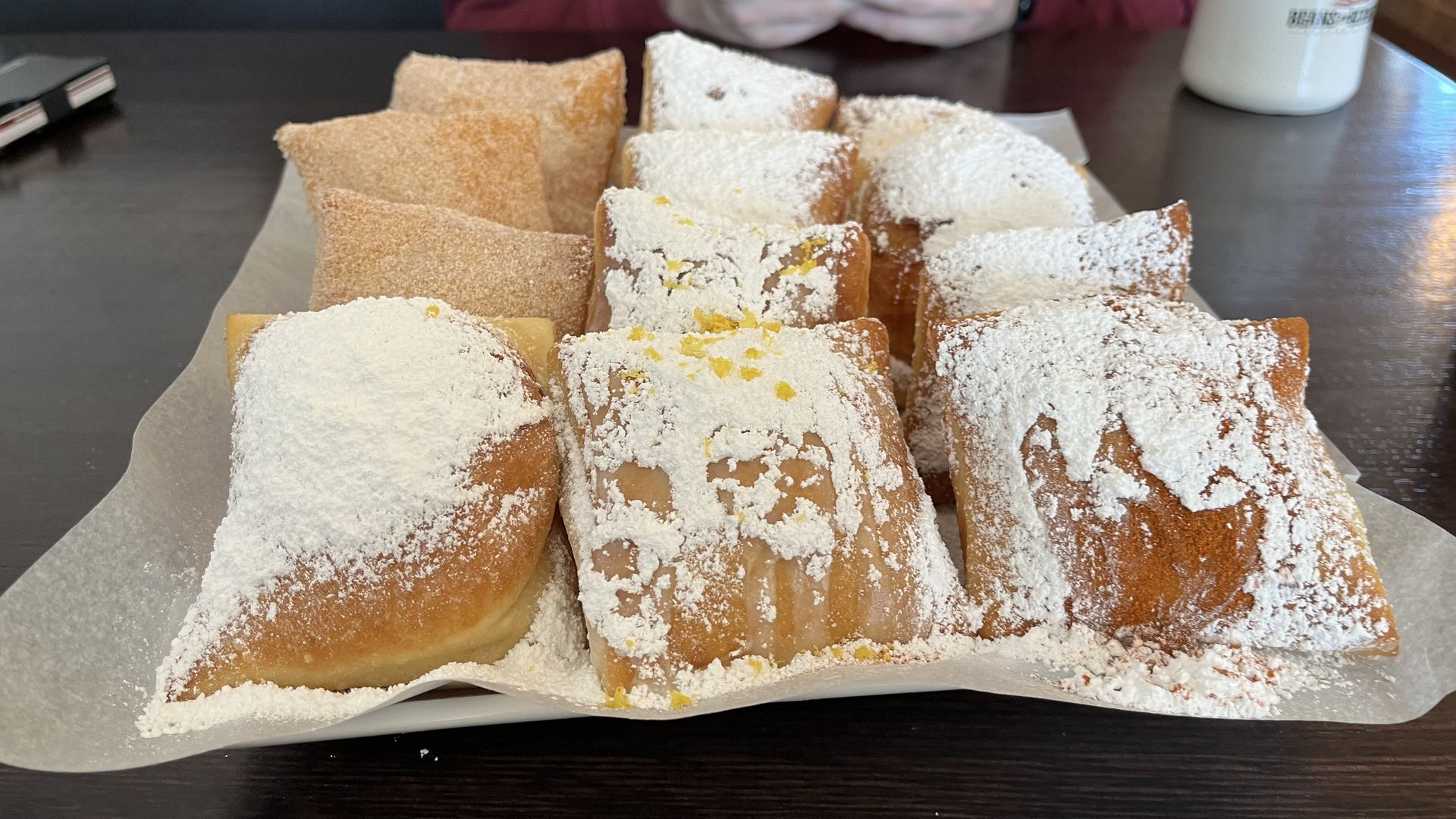 Beignets on a tray in 3 rows