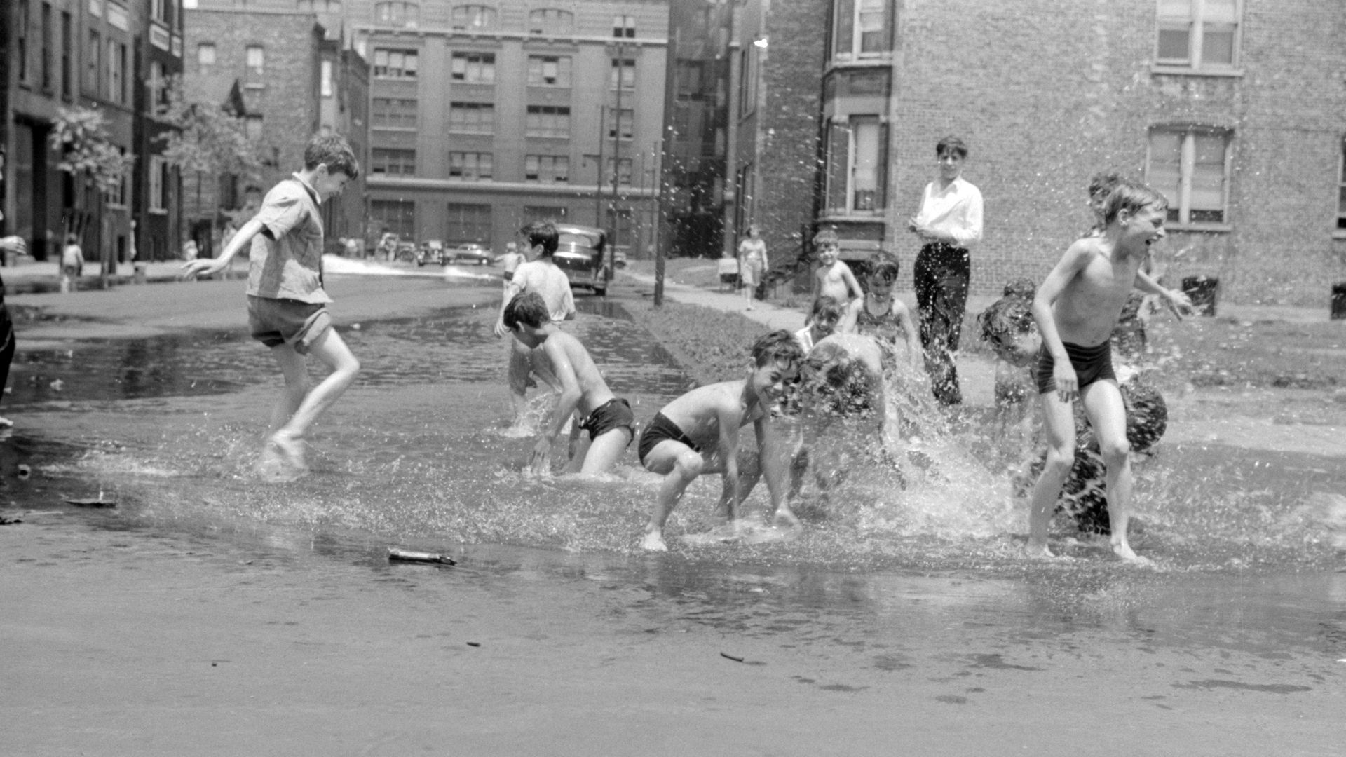 Kids playing in water in the street