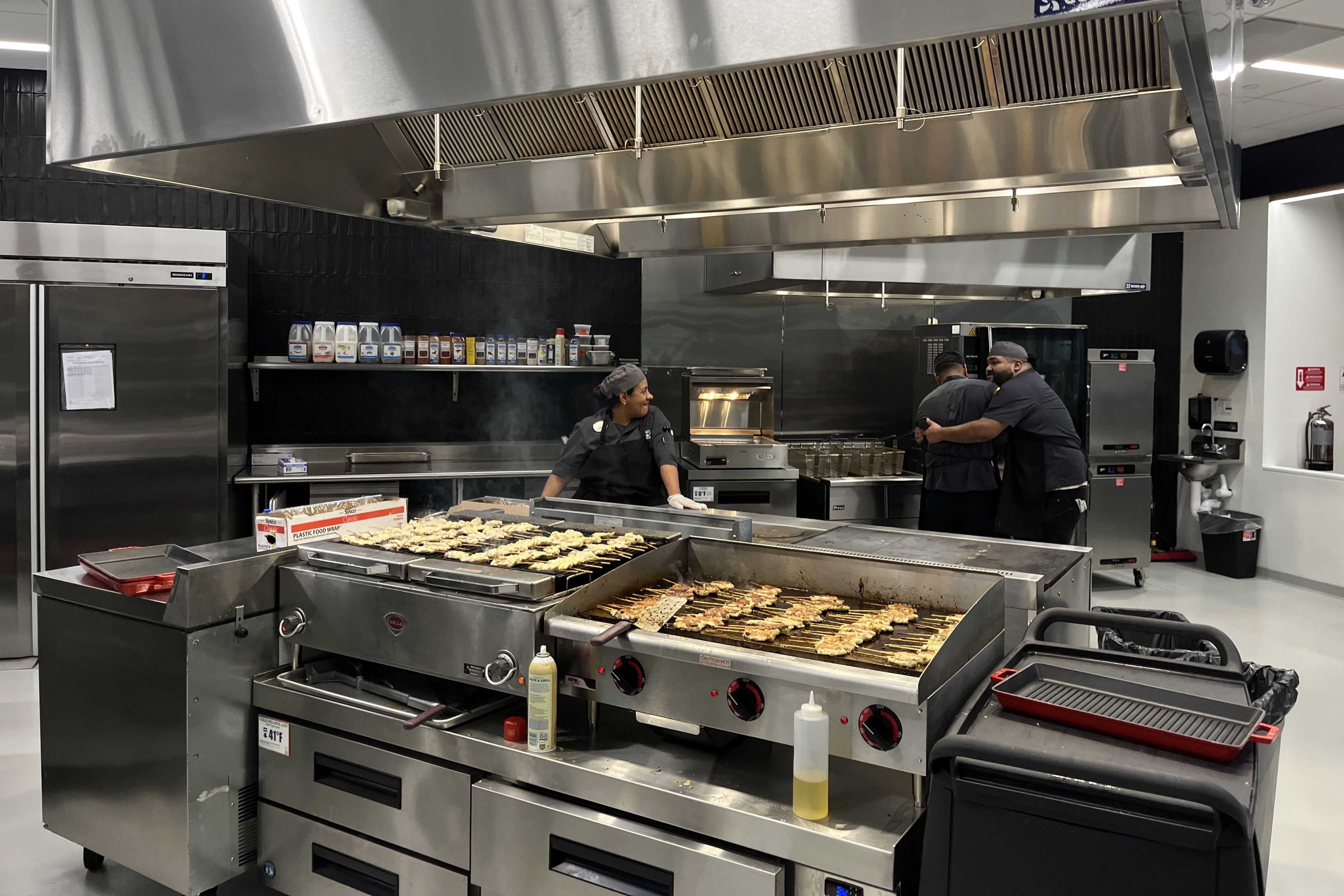 Chefs work in an open-air kitchen