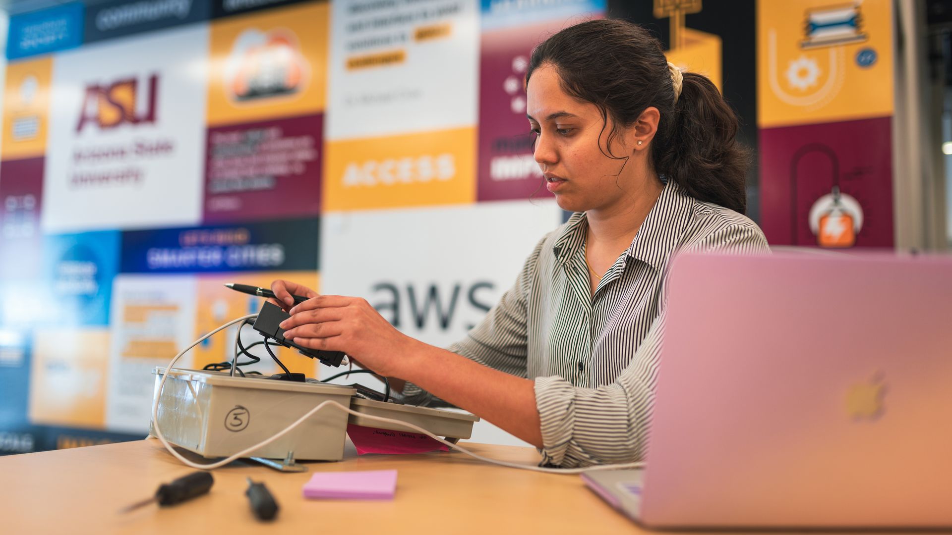 A woman working on a device 