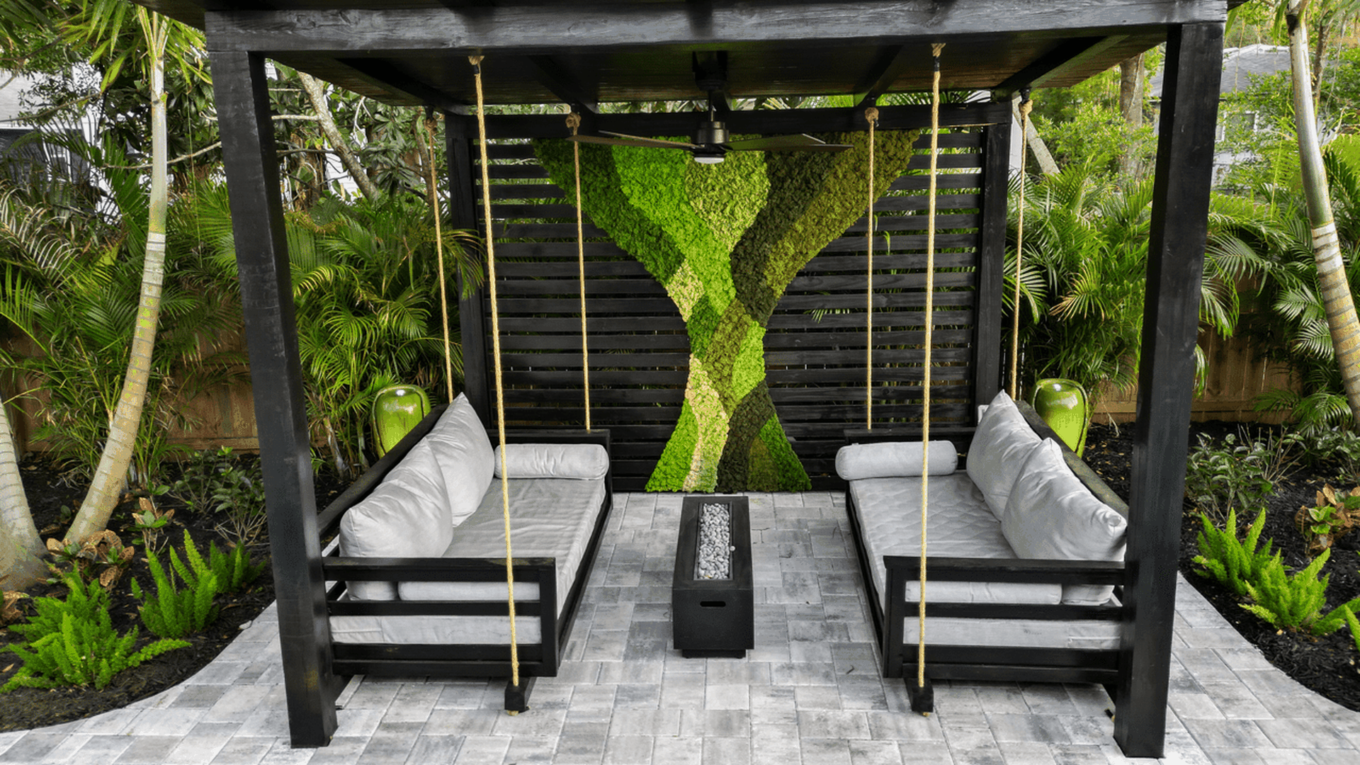 Outdoor seating space with a moss art wall