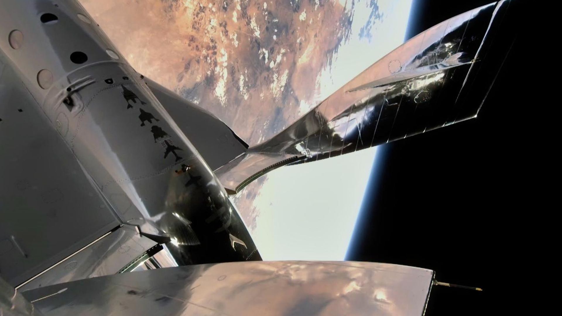 A view of Virgin Galactic's space plane above Earth