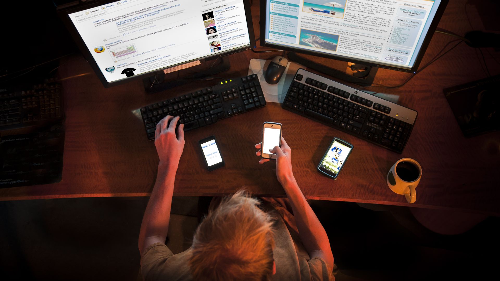 A man using multiple computer screens and smart phones at once