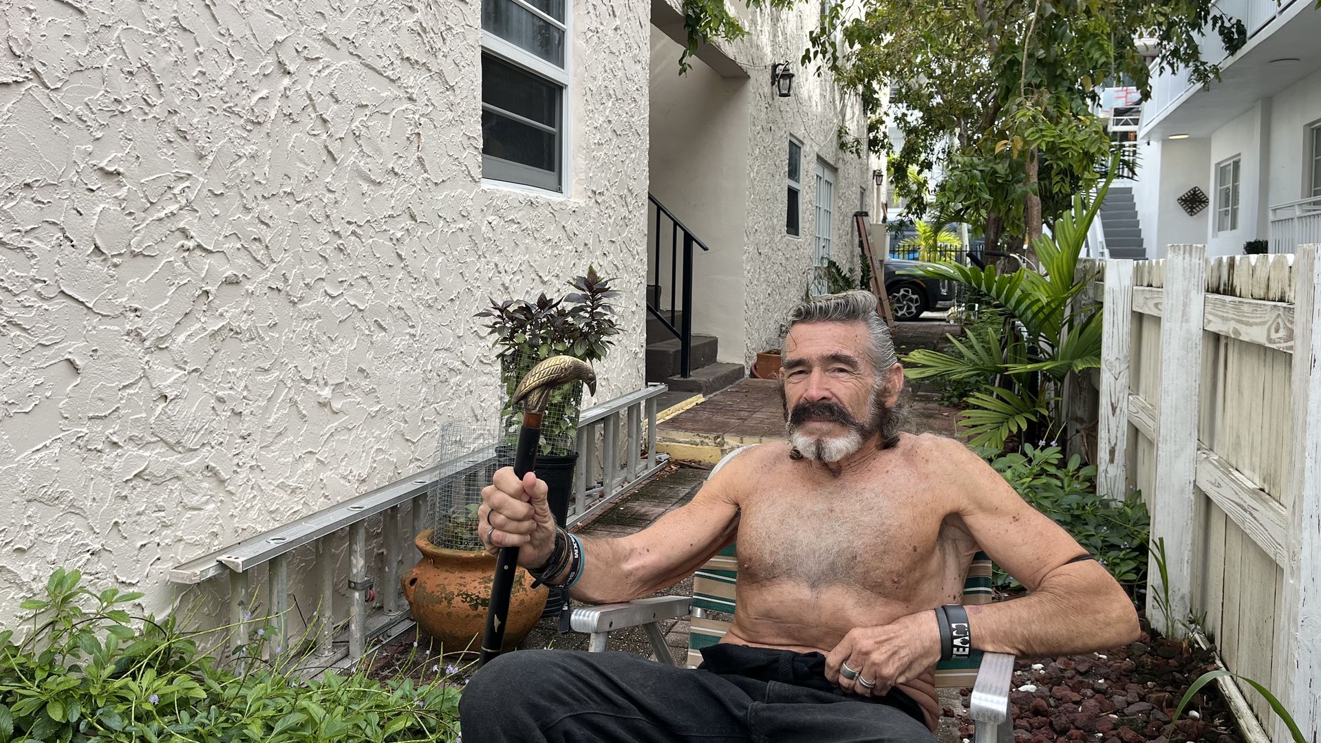 Robert "Raven" Kraft poses with his cane outside his condominium. 