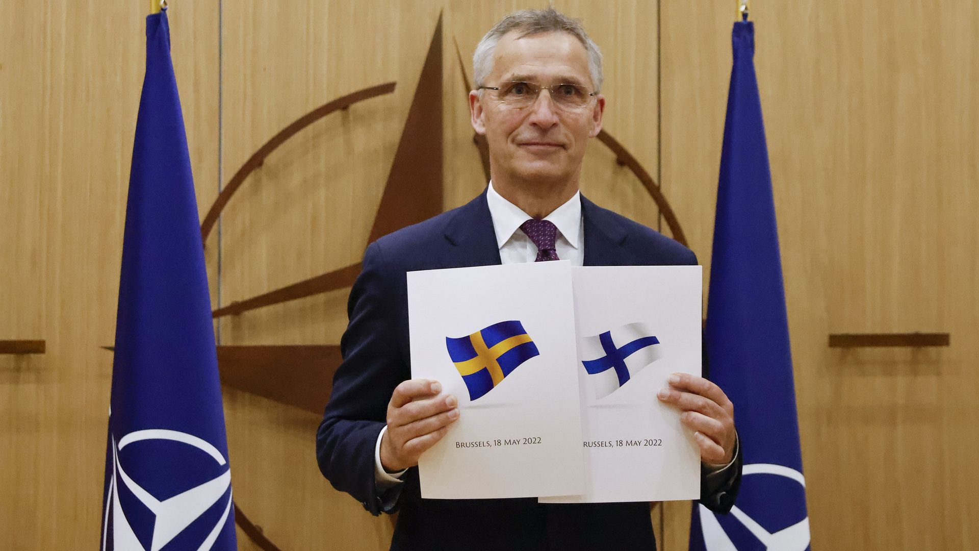 NATO Secretary-General Jens Stoltenberg displays documents from Sweden and Finland in Brussels on May 18.