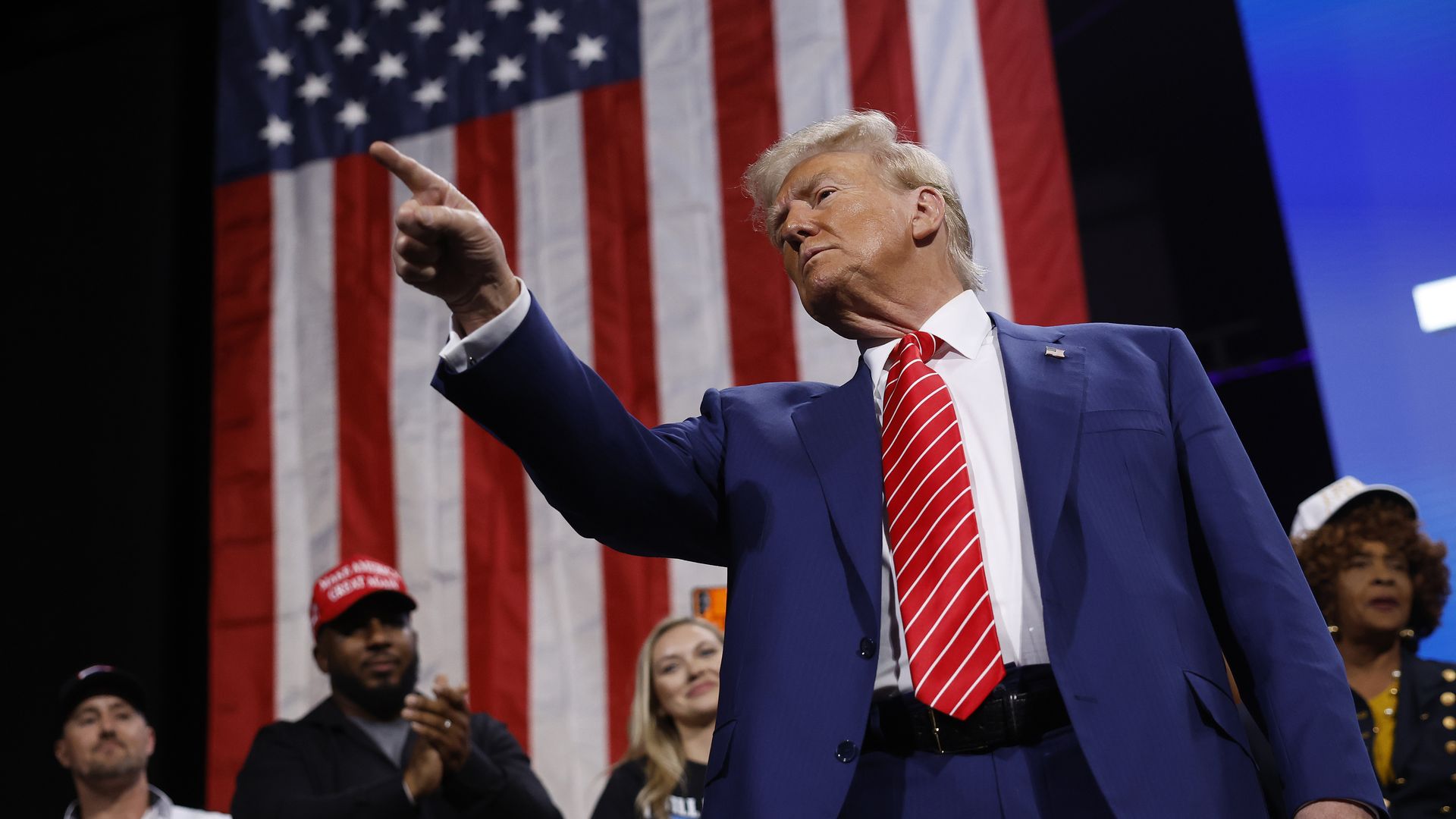 Republican presidential nominee, former U.S. President Donald Trump points to the crowd after delivering remarks during a campaign rally at the Cobb Energy Performing Arts Centre on October 15, 2024 in Atlanta.