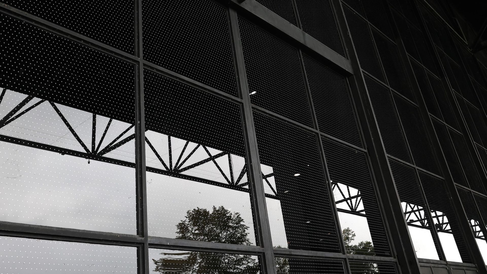 Glass windows between black beams covered in a polka dotted film.