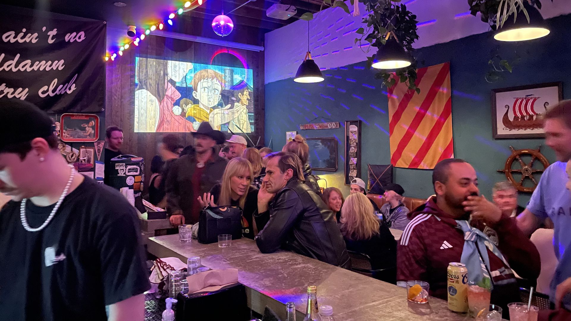 Inside a crowded bar. 