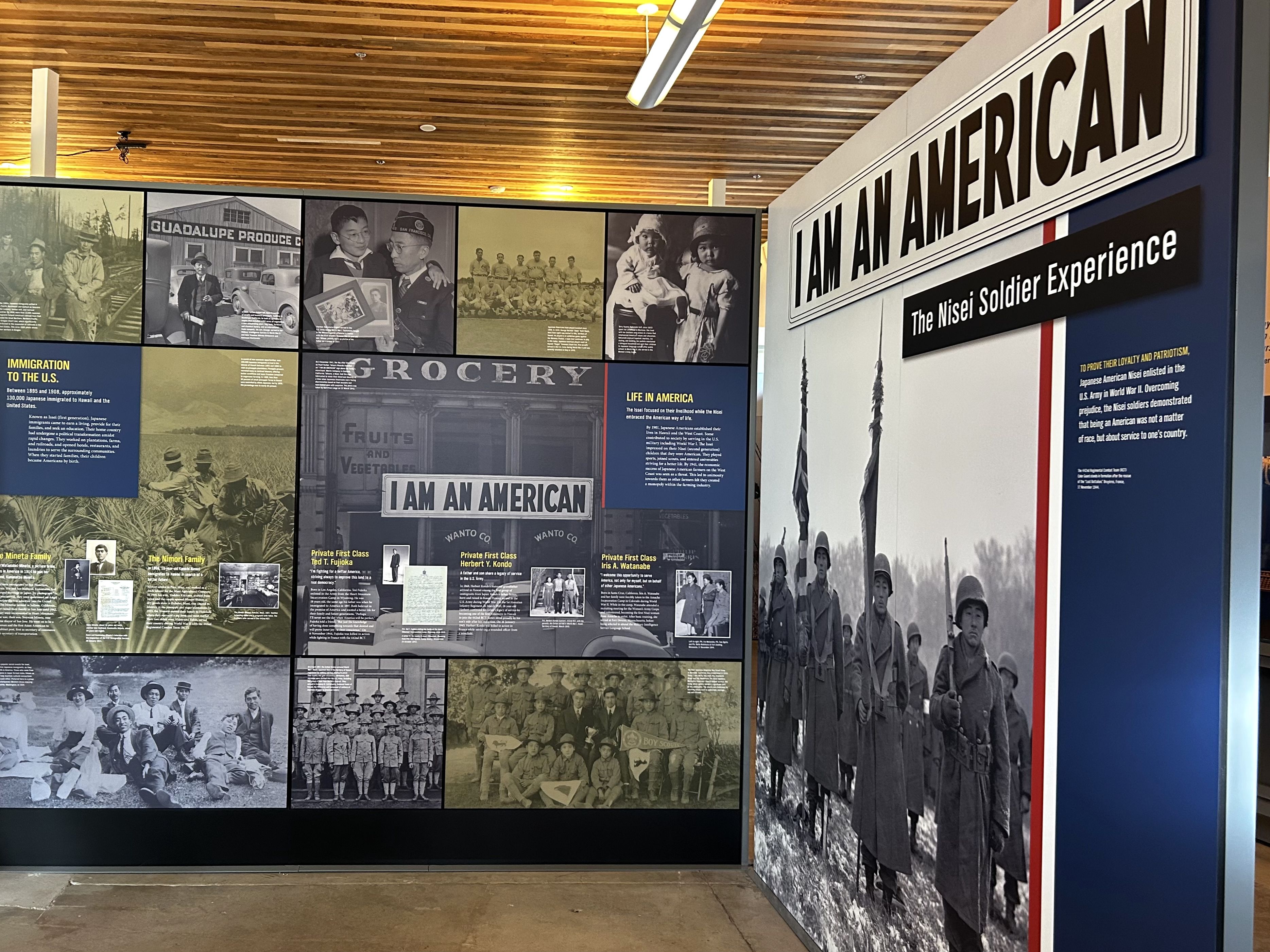 Museum exhibit panels titled "I AM AN AMERICAN," detailing the Nisei Soldier Experience with historical black-and-white photos of Japanese American families and WWII soldiers.