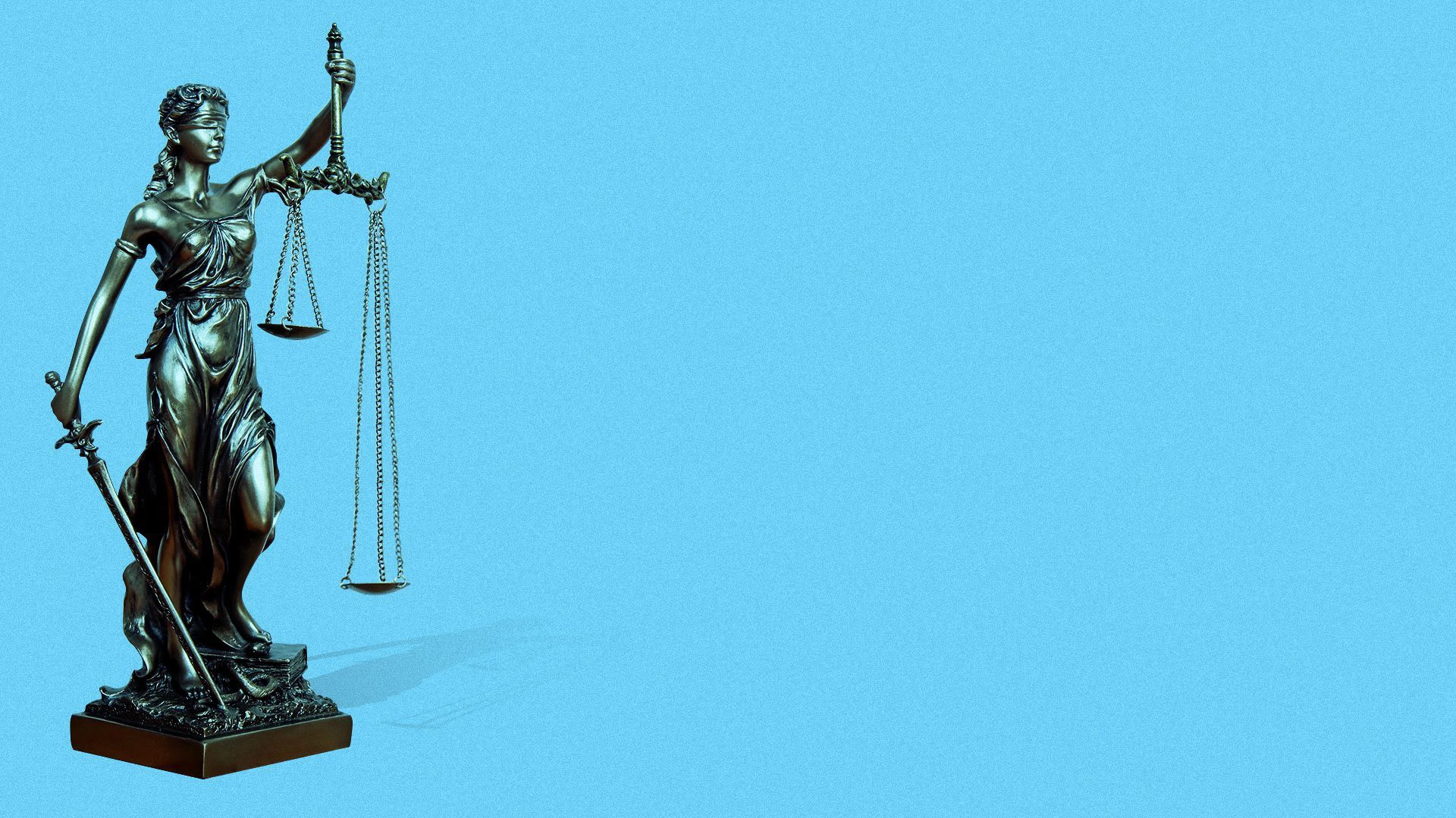 An illustration of a statue holding a sword and scale.