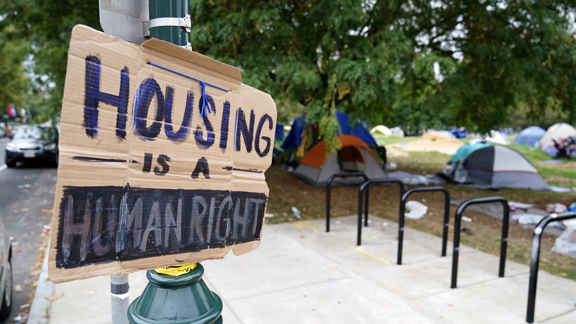 A sign is displayed near a homeless encampment in Philadelphia. Photo: Matt Slocum/AP