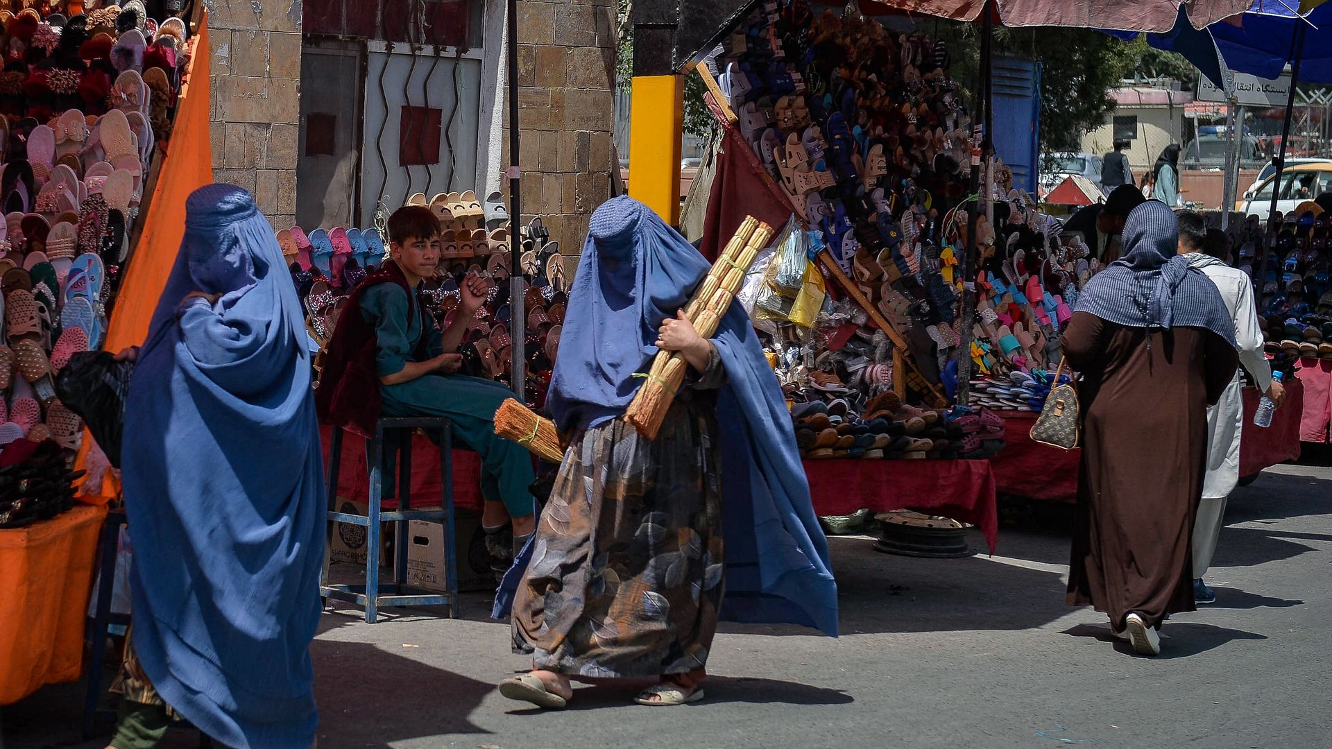 Burqa clad Afghan women shop at a market area in Kabul 