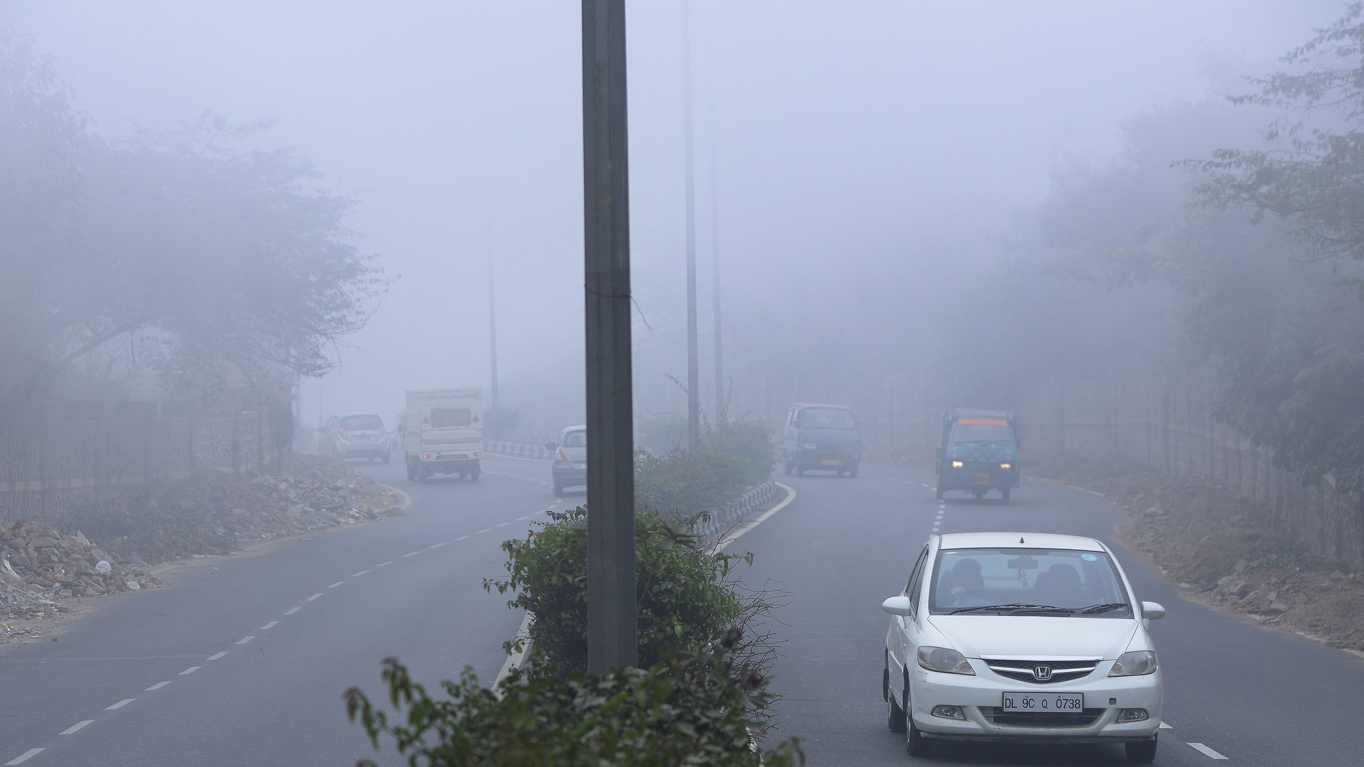 People commute through smog in New Delhi.