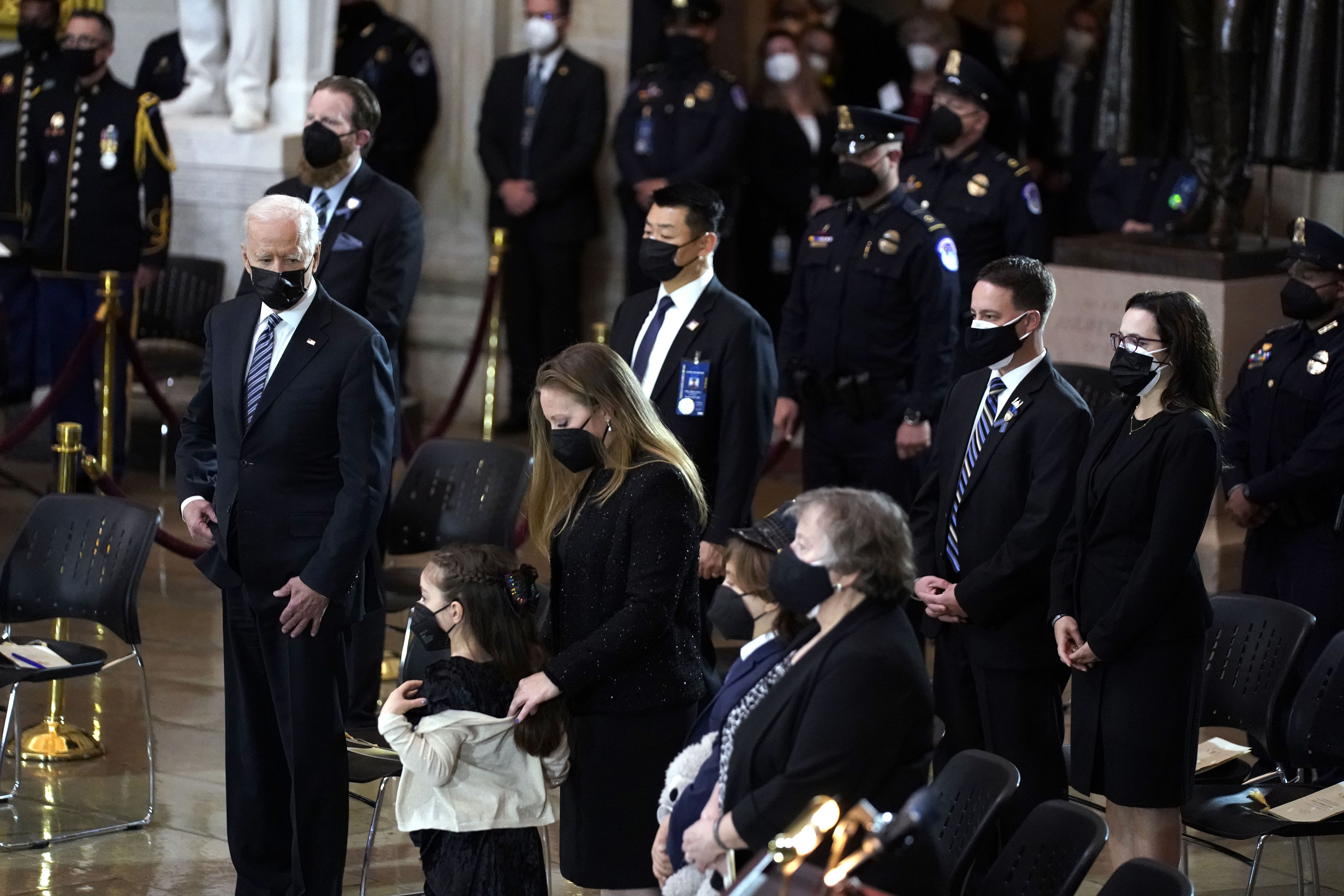 Biden looks on at Evans' family. Photo: Amr Alfiky-Pool/Getty Image