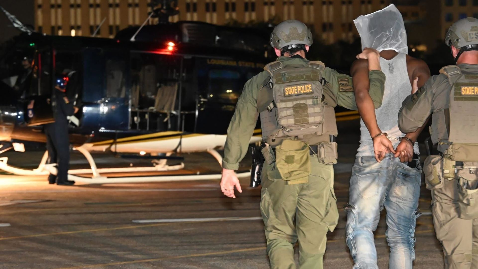 Image shows inmate being escorted