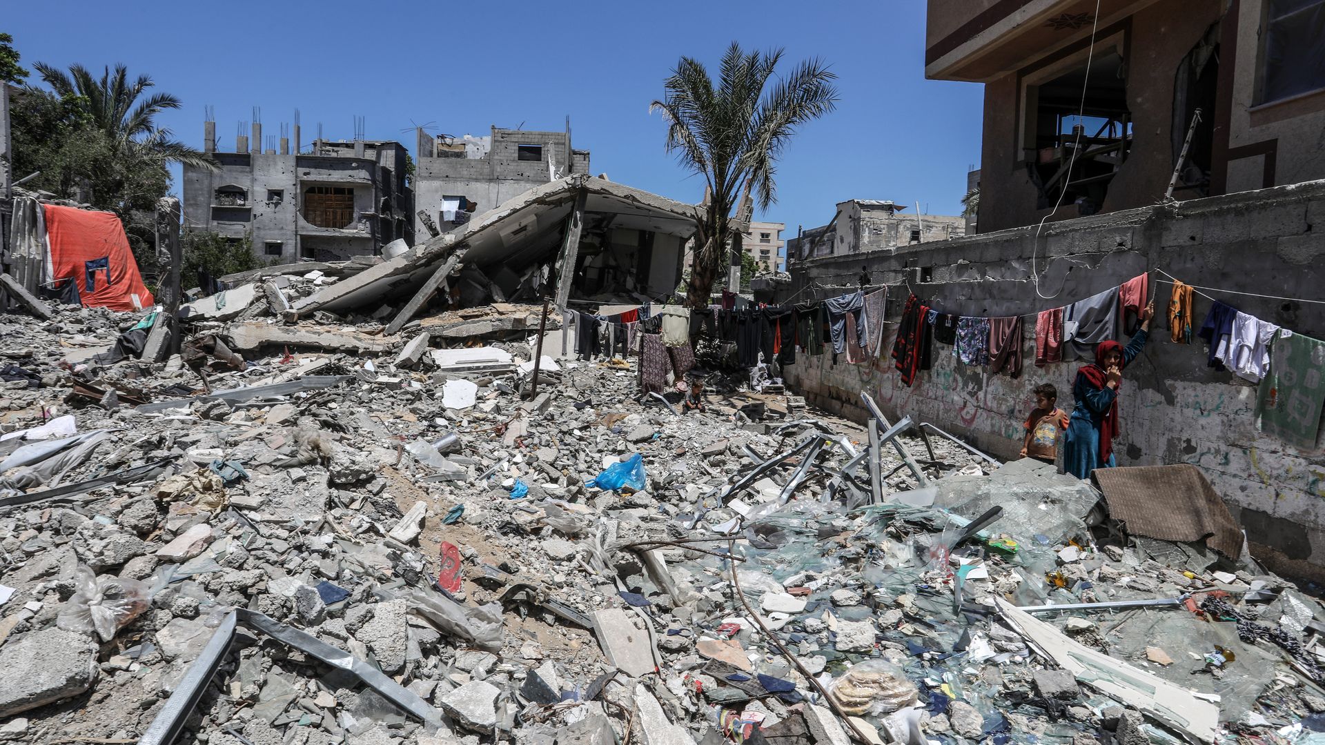 Palestinians, who have sought refuge in Deir al-Balah after the Israeli army targeted tents in Rafah, previously declared as a 'safe zone' by Israel, are struggling to survive among the rubble of destroyed buildings under harsh conditions in Deir Al Balah, Gaza on May 30,