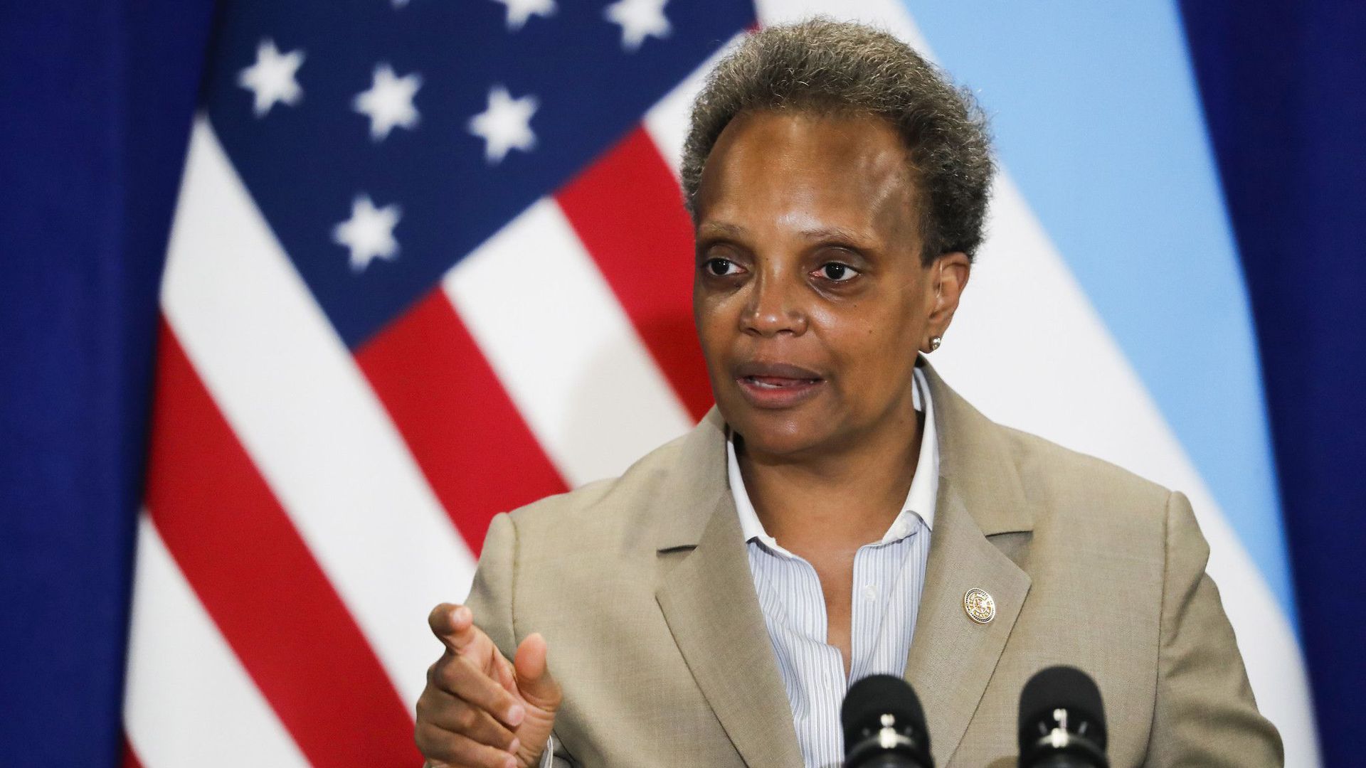 Chicago Mayor Lori Lightfoot speaks in front of a microphone