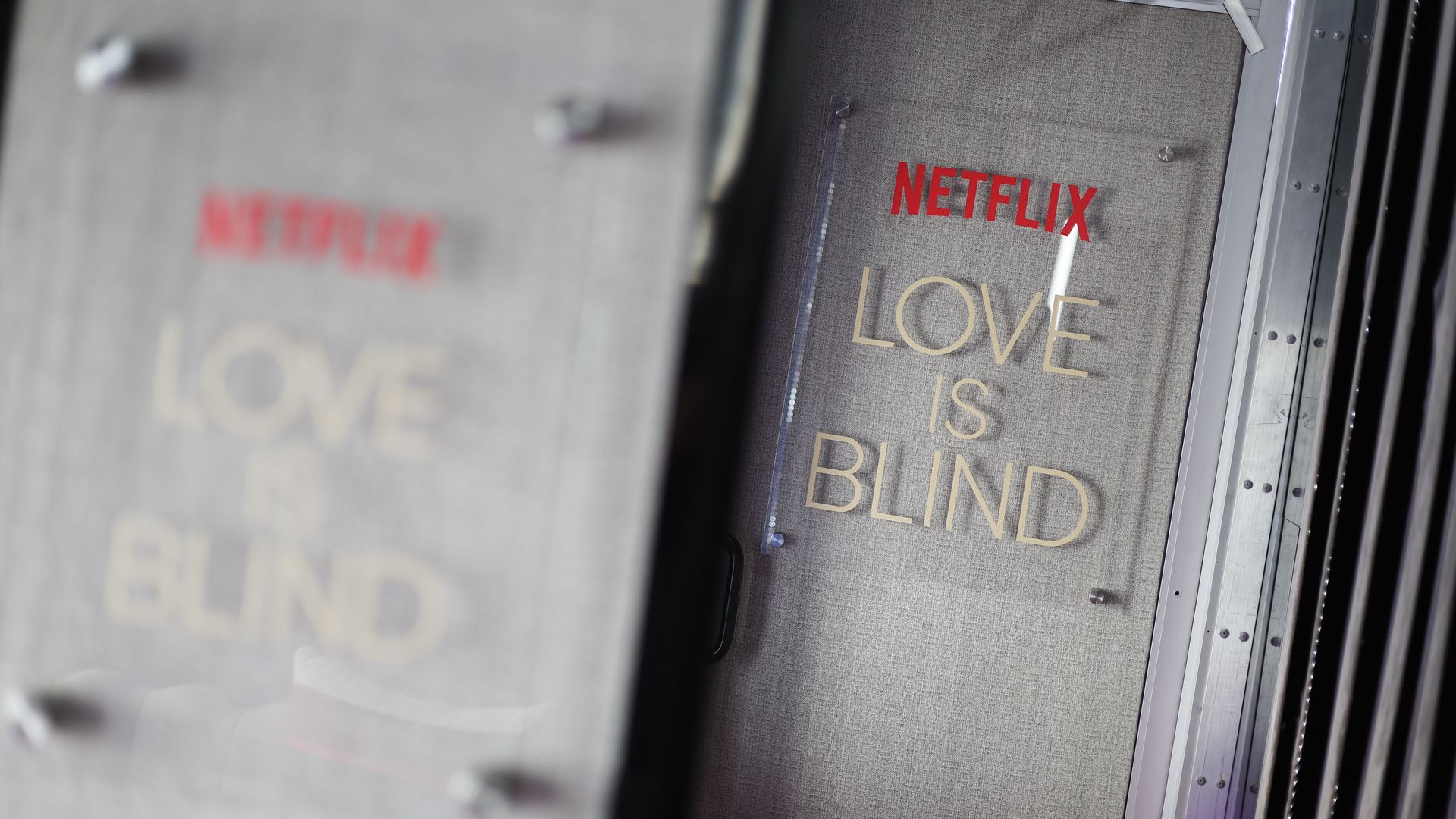 Placards reading "Netflix Love Is Blind."