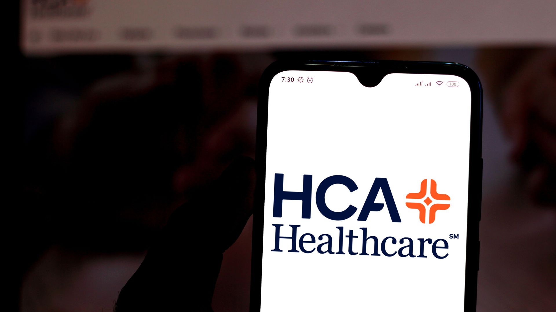 Picture of a phone that has the HCA Healthcare logo displayed on the screen