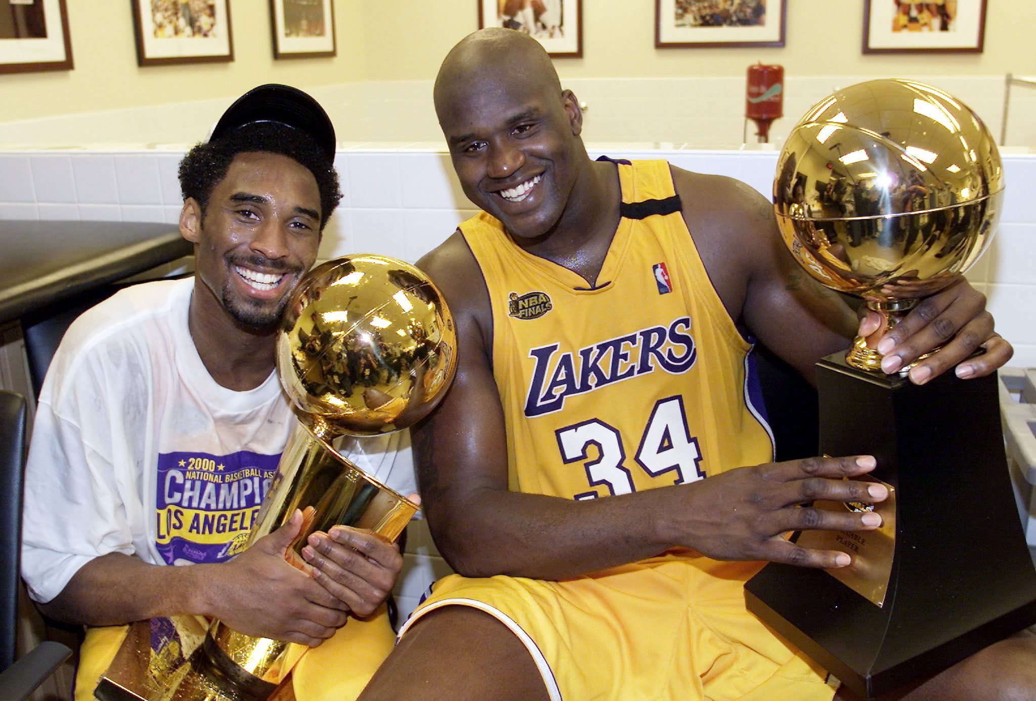 Kobe Bryant holds the Larry O'Brian trophy with teammate Shaquille O'Neal