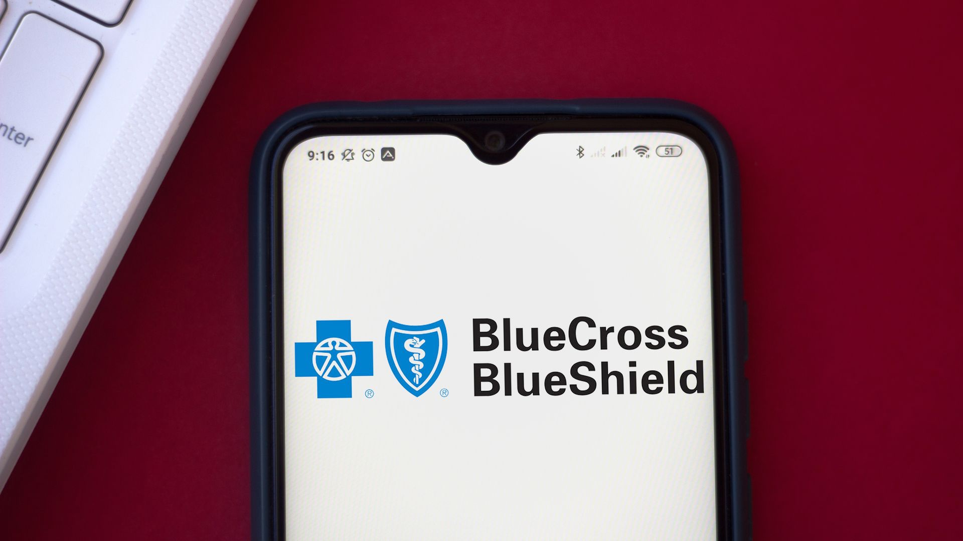 The Blue Cross and Blue Shield logo on a phone.