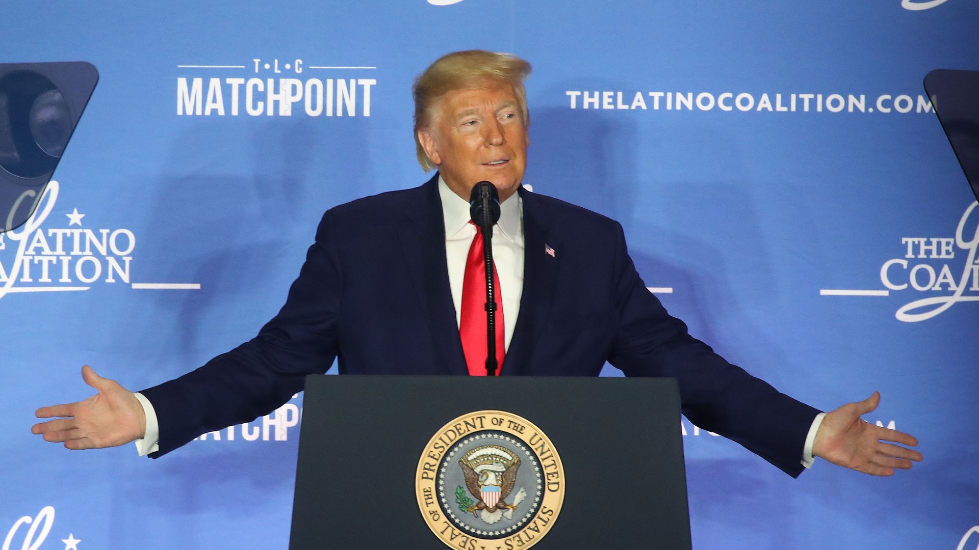 President Trump with his arms spread wide.